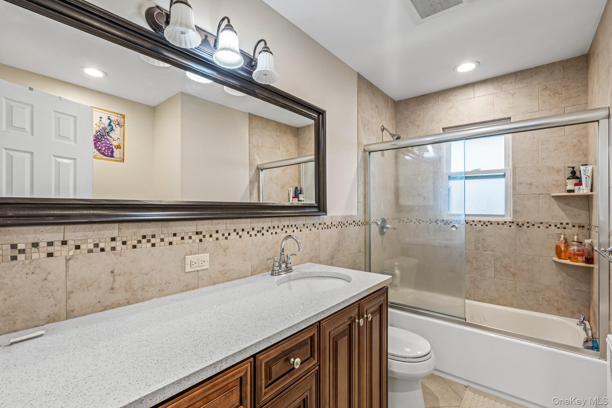 15 Vista Road Plainview, NY 11803 - Photo 14 of 26 a bathroom with a sink a toilet and shower