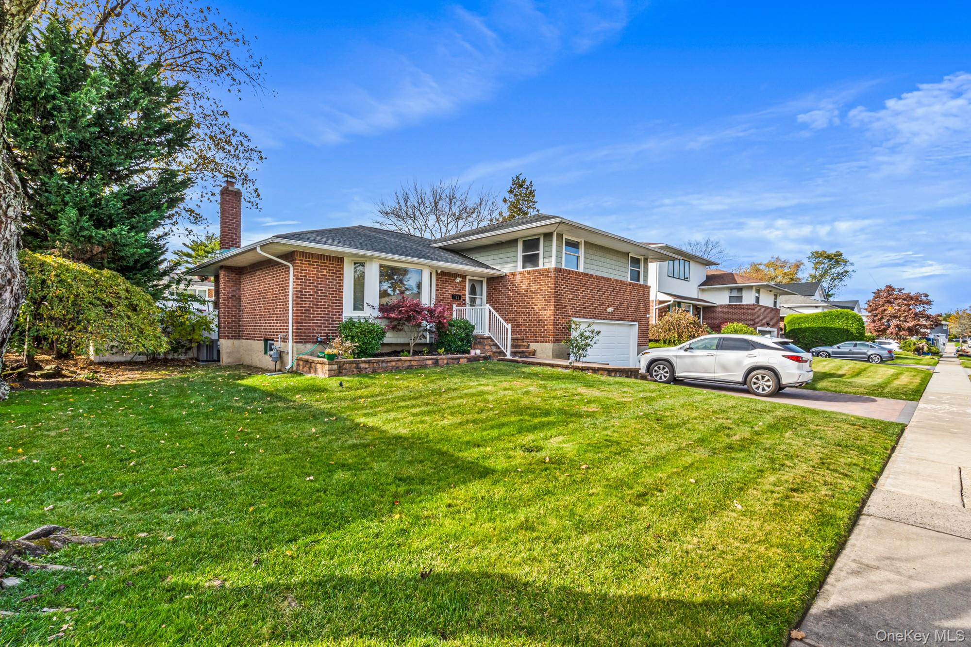 15 Vista Road Plainview, NY 11803 - Photo 3 of 26 a front view of a house with garden