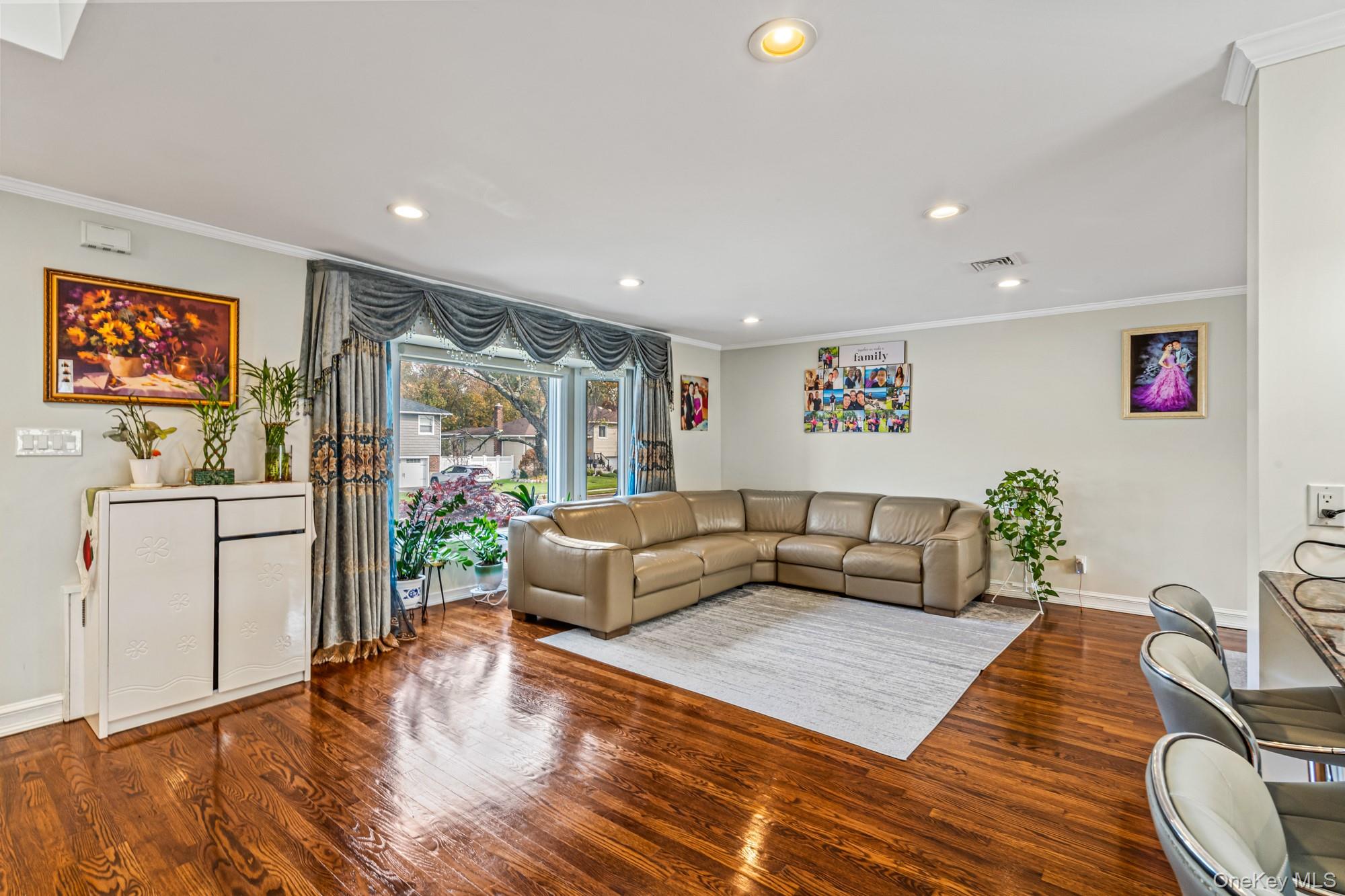 15 Vista Road Plainview, NY 11803 - Photo 6 of 26 a living room with furniture and a flat screen tv