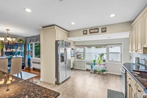 a kitchen with stainless steel appliances granite countertop a refrigerator and a sink