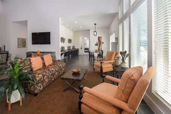 a dining room with furniture a window and wooden floor