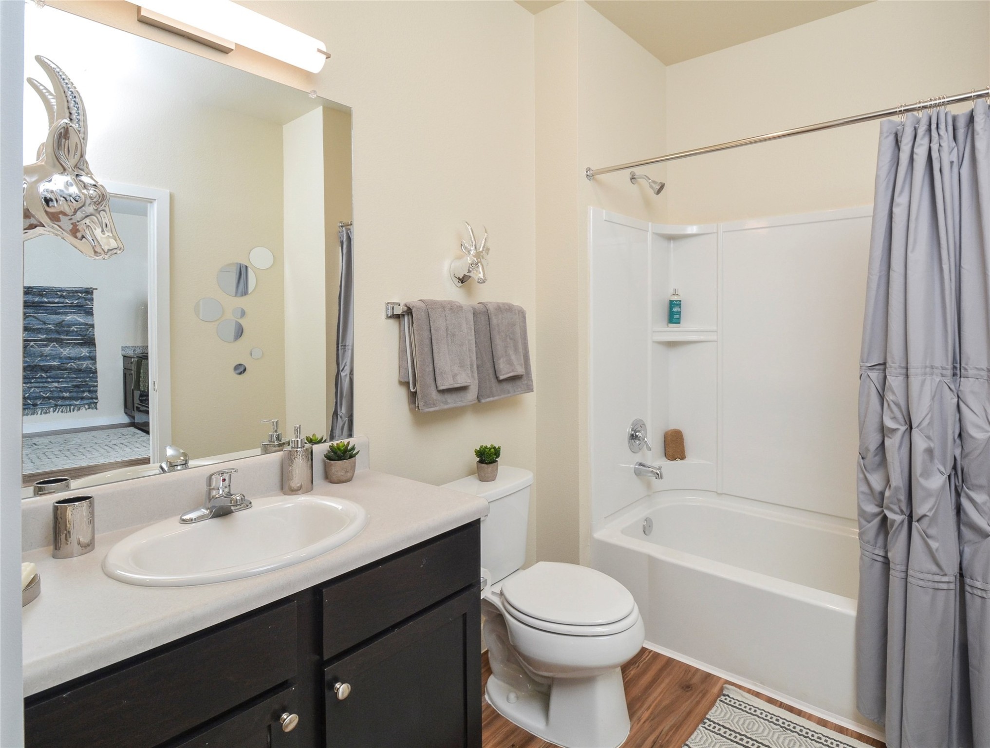10148 Culebra Road San Antonio, TX 78251 - Photo 2 of 15 a bathroom with a sink toilet a mirror and shower