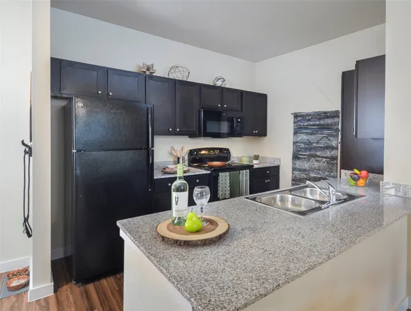 a kitchen with refrigerator and breakfast area