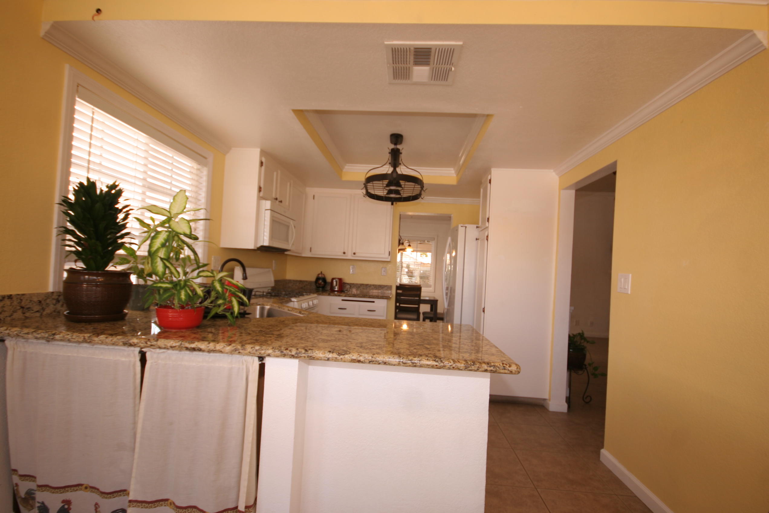 45736 Sutter Creek Road Indio, CA 92201 - Photo 13 of 44 a kitchen with a sink and a refrigerator