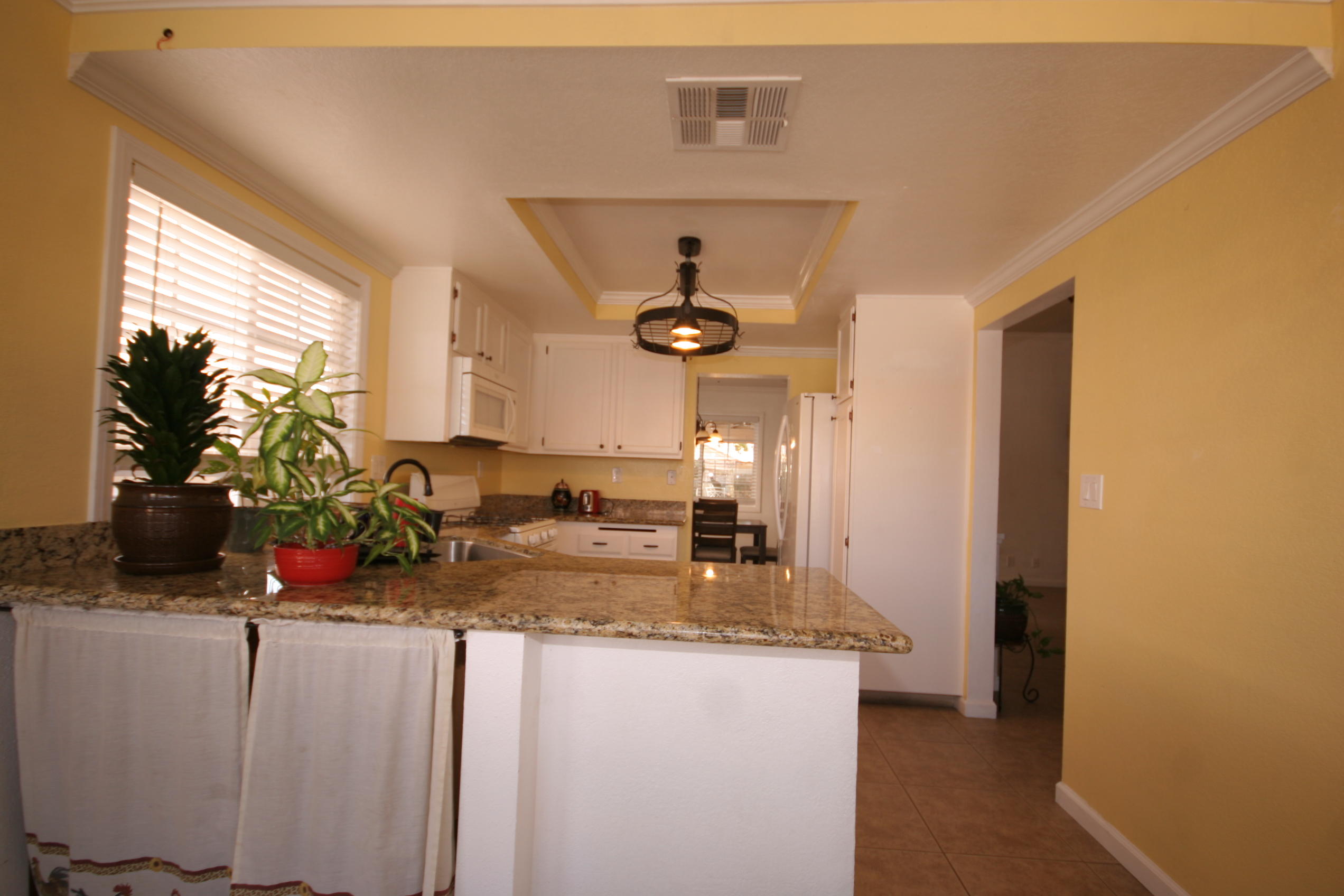 45736 Sutter Creek Road Indio, CA 92201 - Photo 14 of 44 a view of living room with granite countertop furniture and a flat screen tv