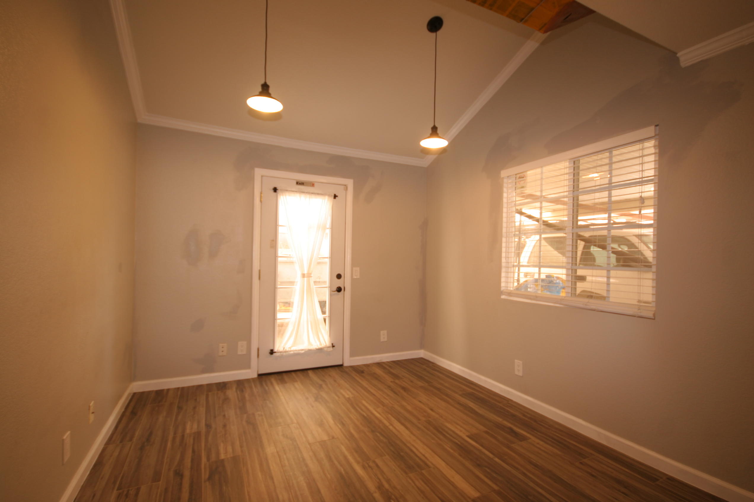 45736 Sutter Creek Road Indio, CA 92201 - Photo 20 of 44 a view of an empty room with wooden floor and a window