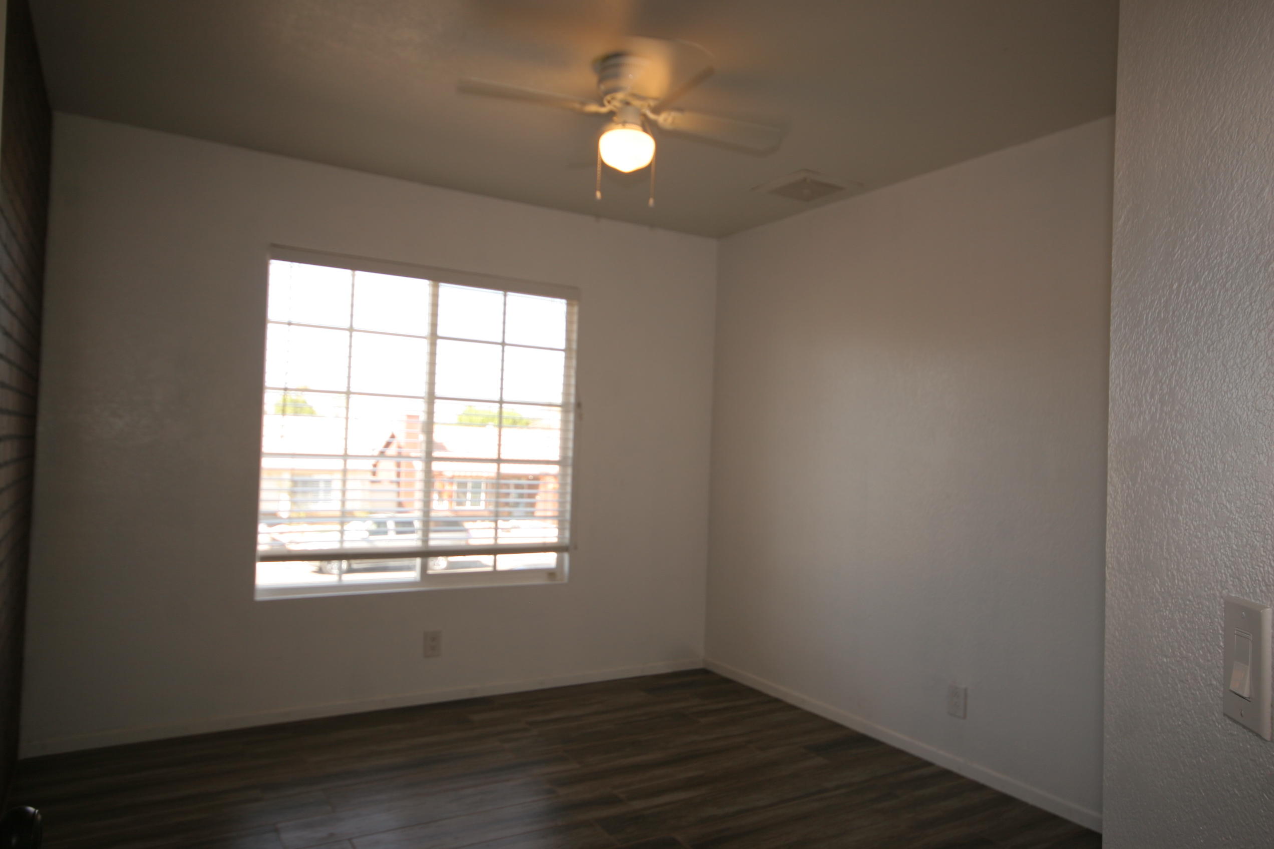 45736 Sutter Creek Road Indio, CA 92201 - Photo 25 of 44 an empty room with wooden floor and windows