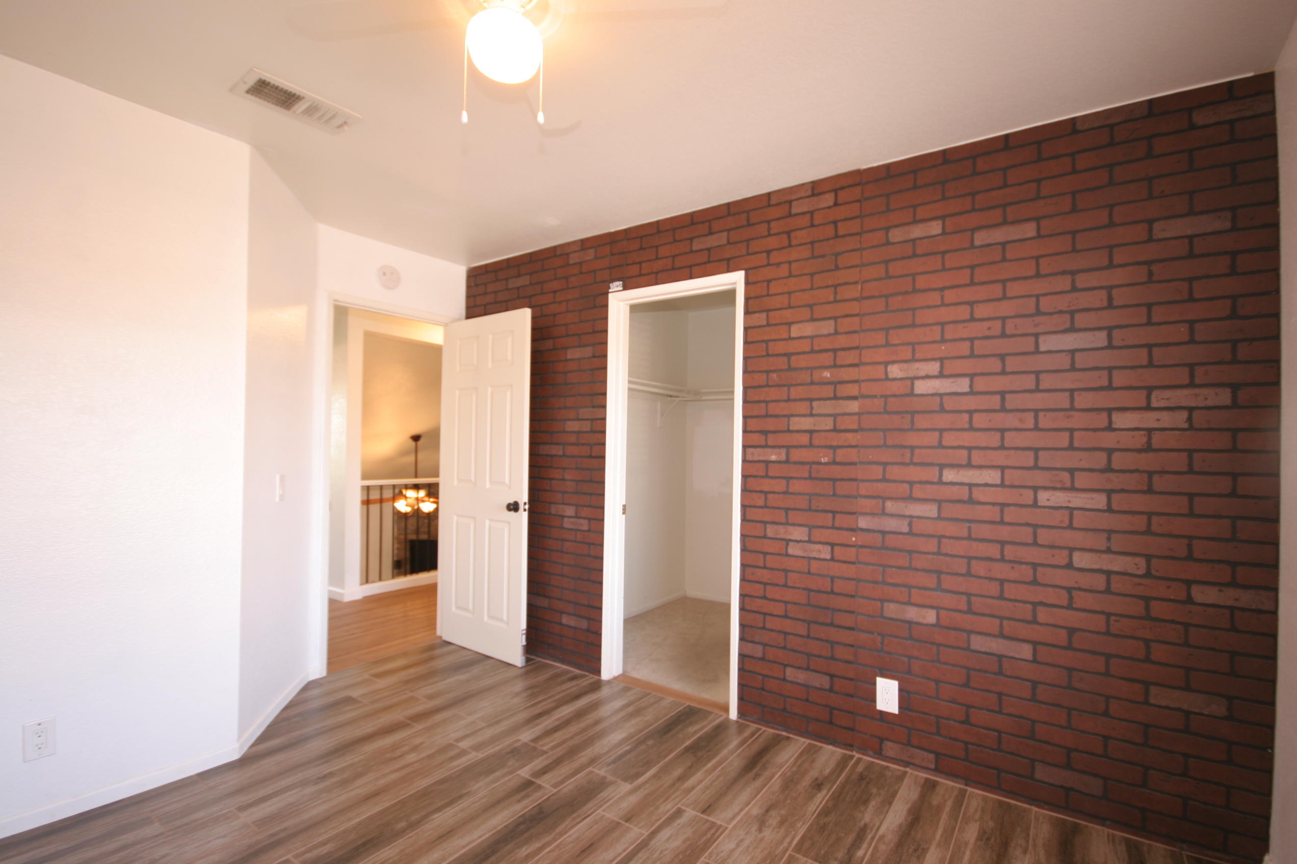 45736 Sutter Creek Road Indio, CA 92201 - Photo 27 of 44 a view of an empty room with wooden floor and a bathroom