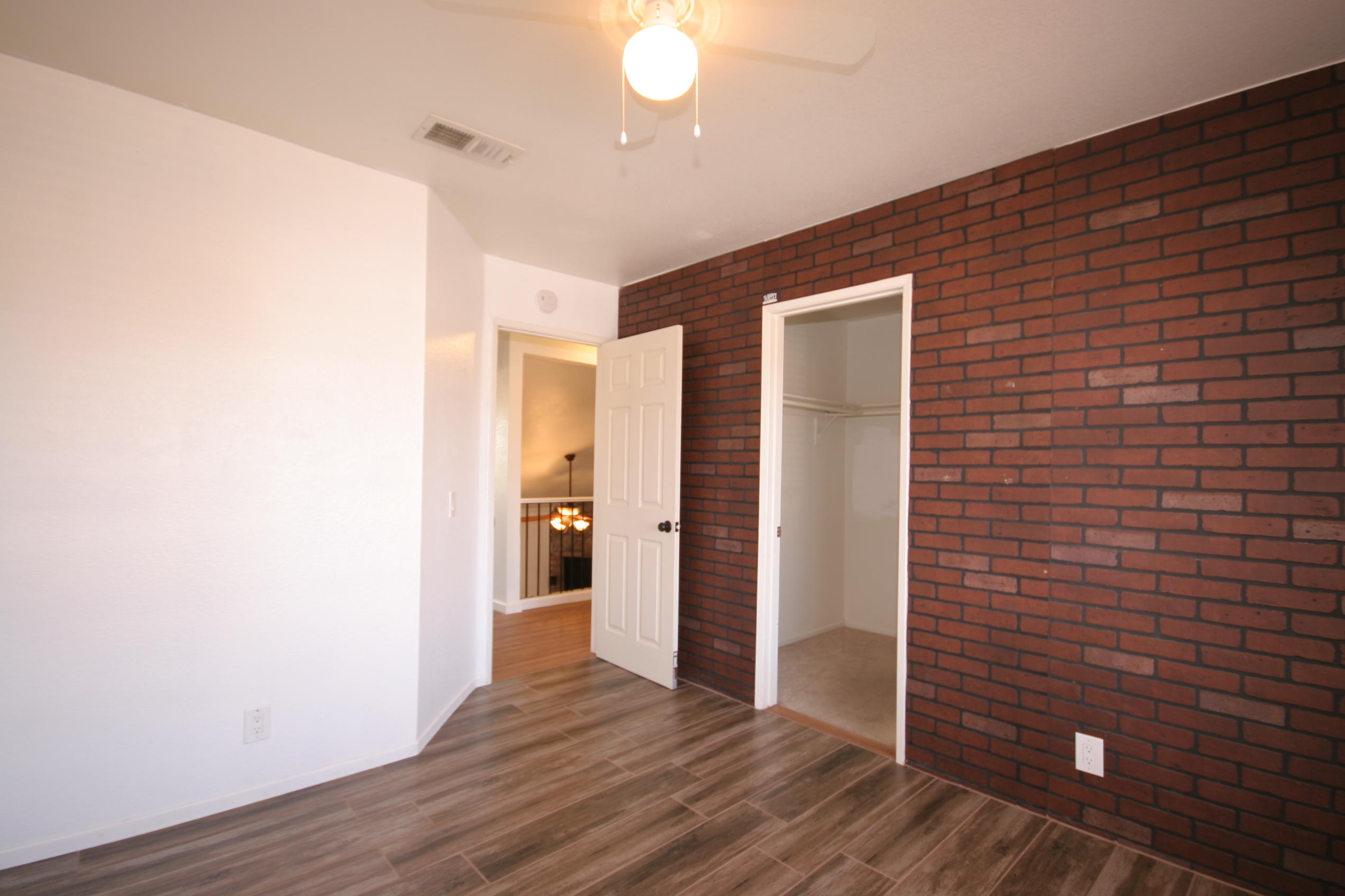 45736 Sutter Creek Road Indio, CA 92201 - Photo 28 of 44 a view of an empty room with wooden floor and a window