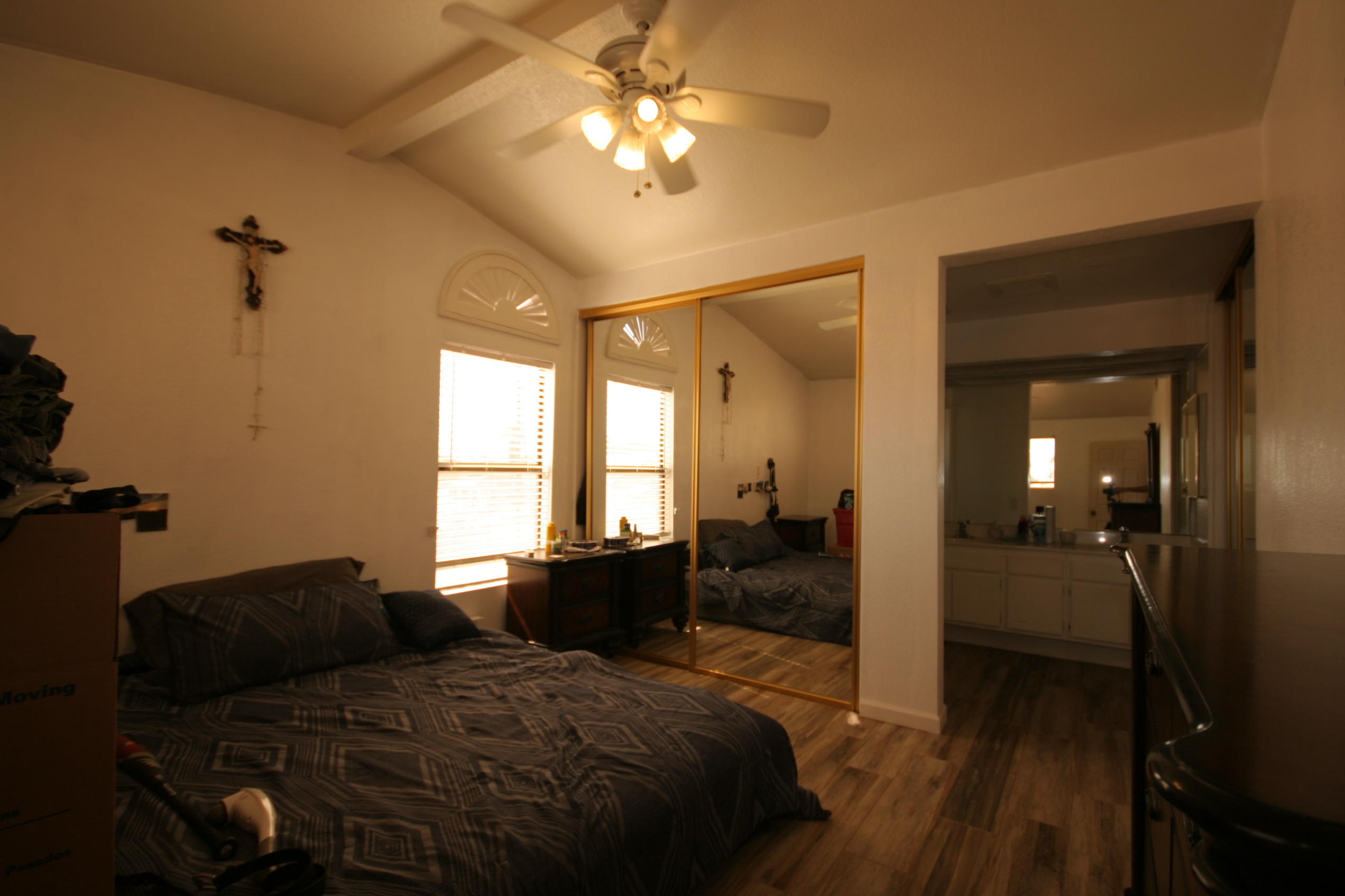 45736 Sutter Creek Road Indio, CA 92201 - Photo 34 of 44 a bedroom with a bed and a chandelier