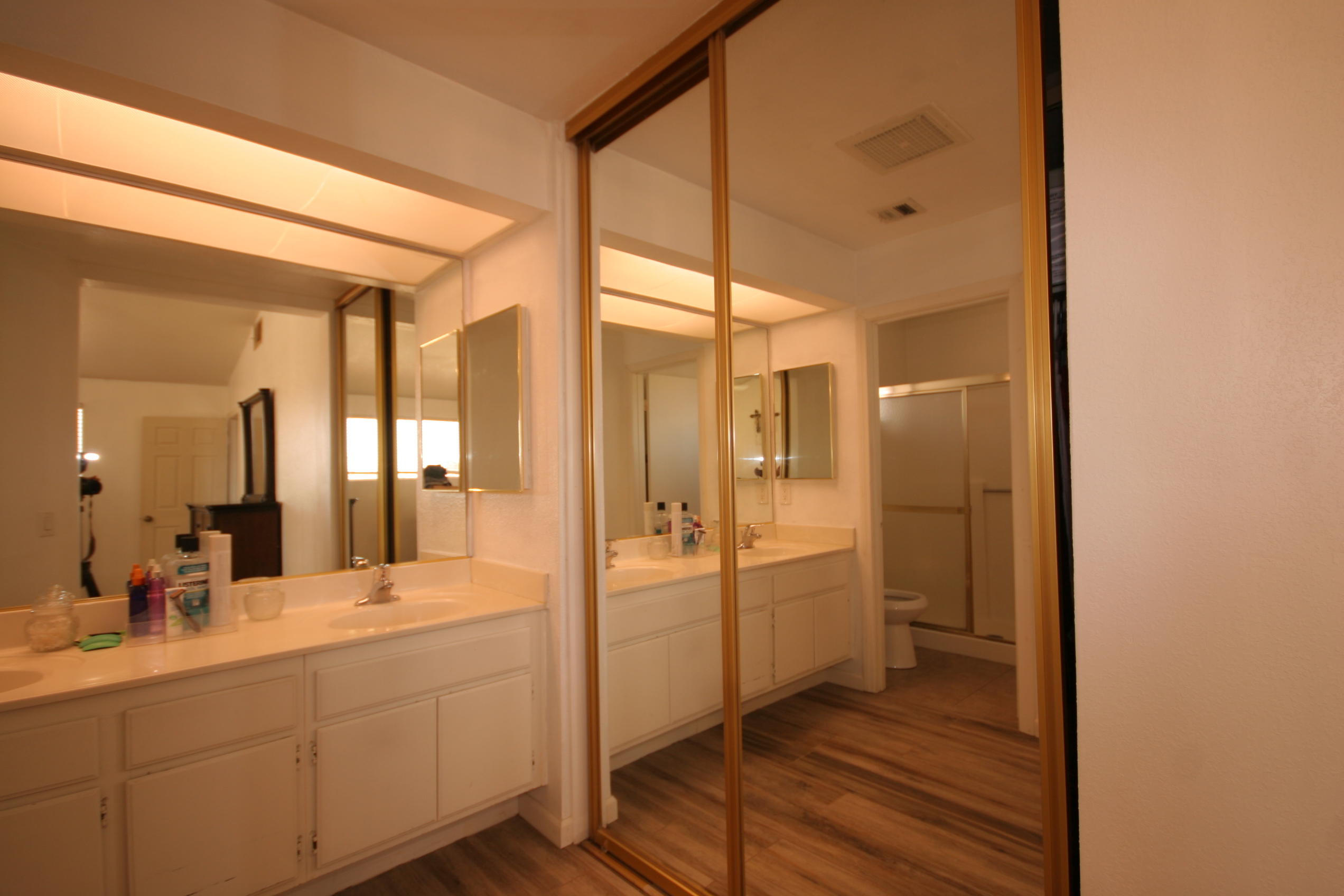 45736 Sutter Creek Road Indio, CA 92201 - Photo 35 of 44 a bathroom with a double vanity sink a mirror and a shower
