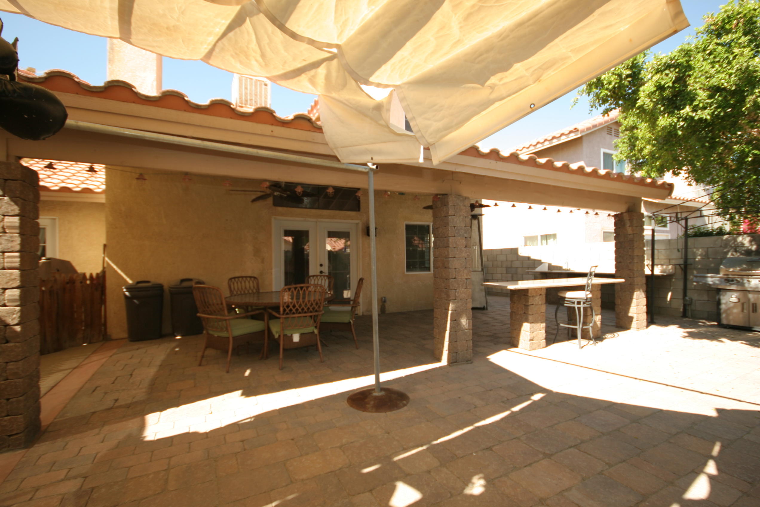 45736 Sutter Creek Road Indio, CA 92201 - Photo 40 of 44 a view of a patio with table and chairs with wooden floor and fence