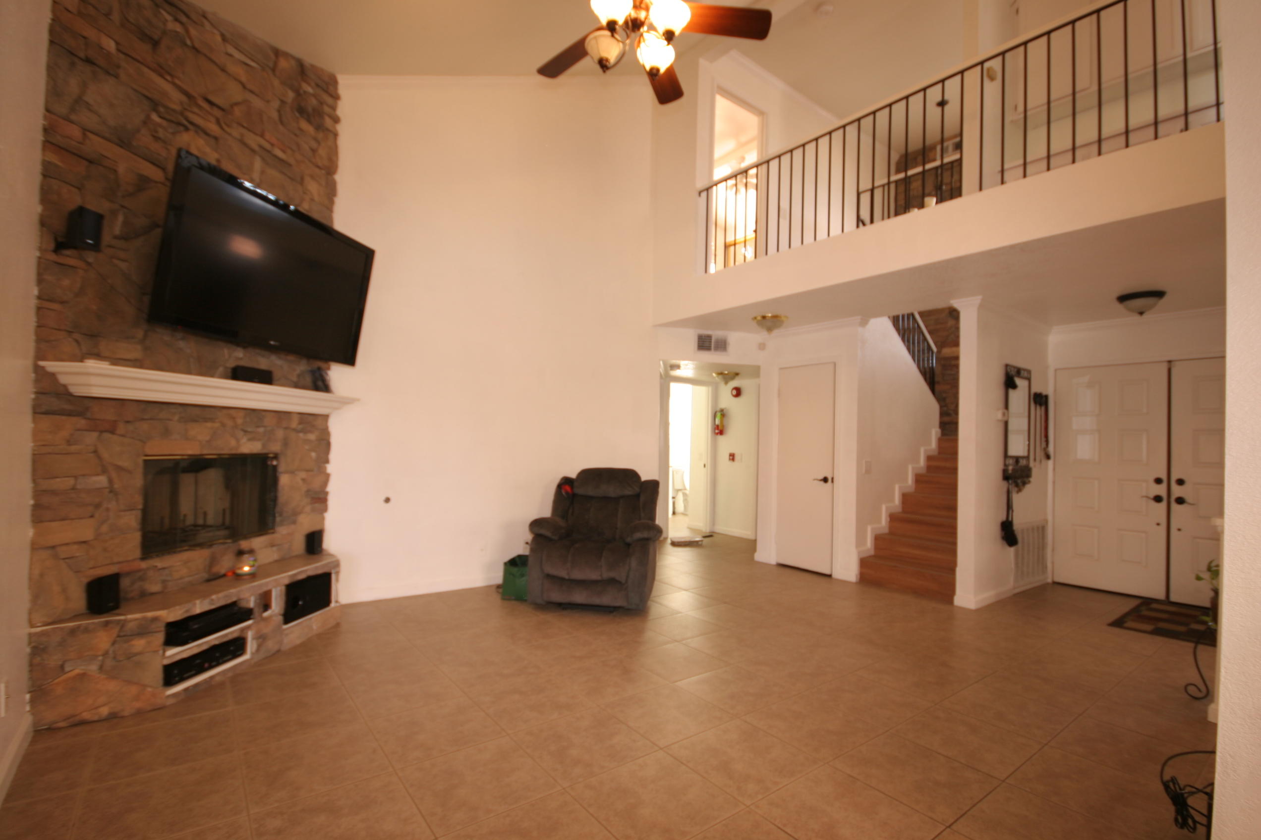 45736 Sutter Creek Road Indio, CA 92201 - Photo 7 of 44 a living room with furniture a flat screen tv and a fireplace