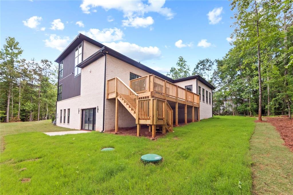 7066 Bells Way Fairburn, GA 30213 - Photo 63 of 64 a white house that has a big yard with wooden fence