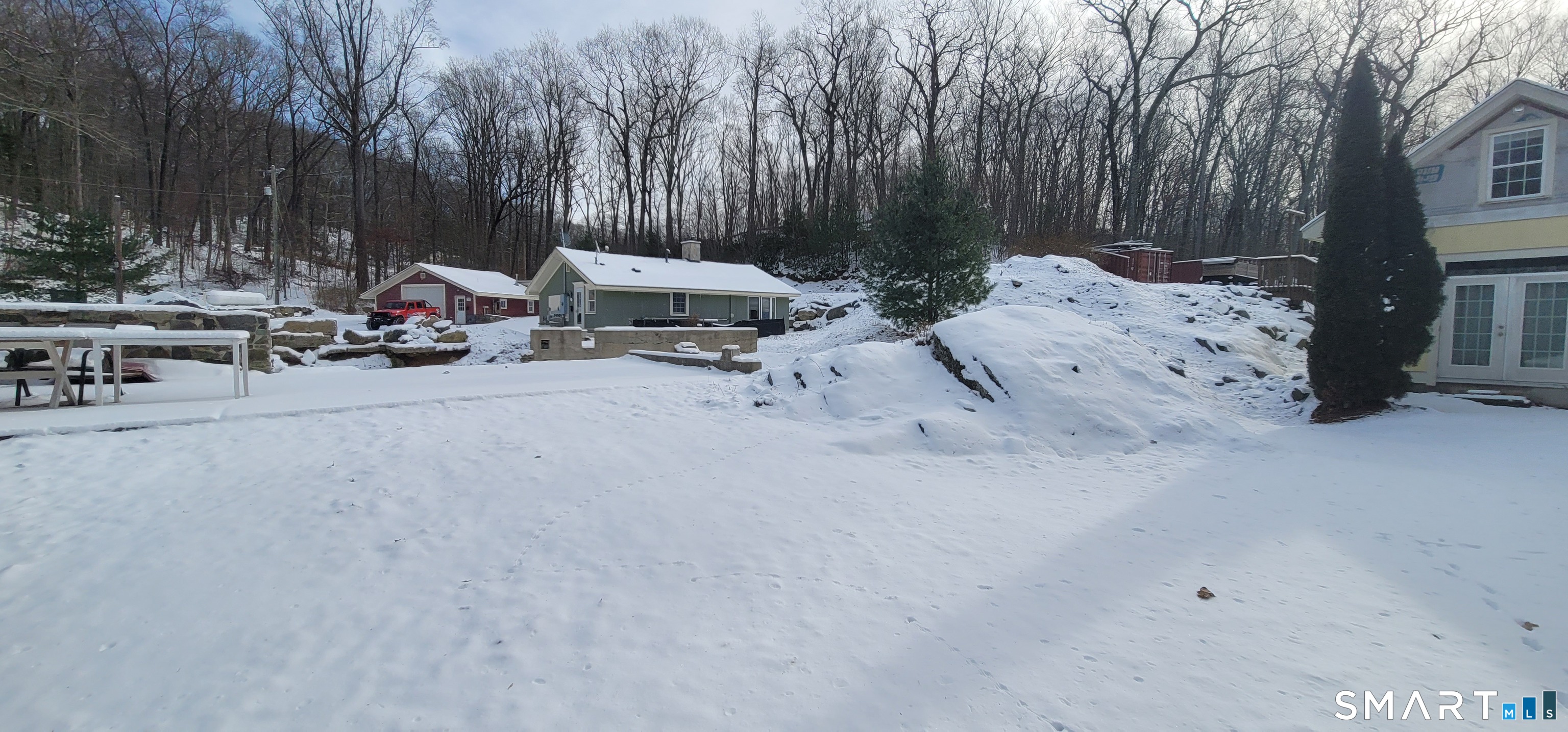 134 Nashville Road Bethel, CT 06801 - Photo 35 of 36 a view of backyard with a table and chairs and a barbeque