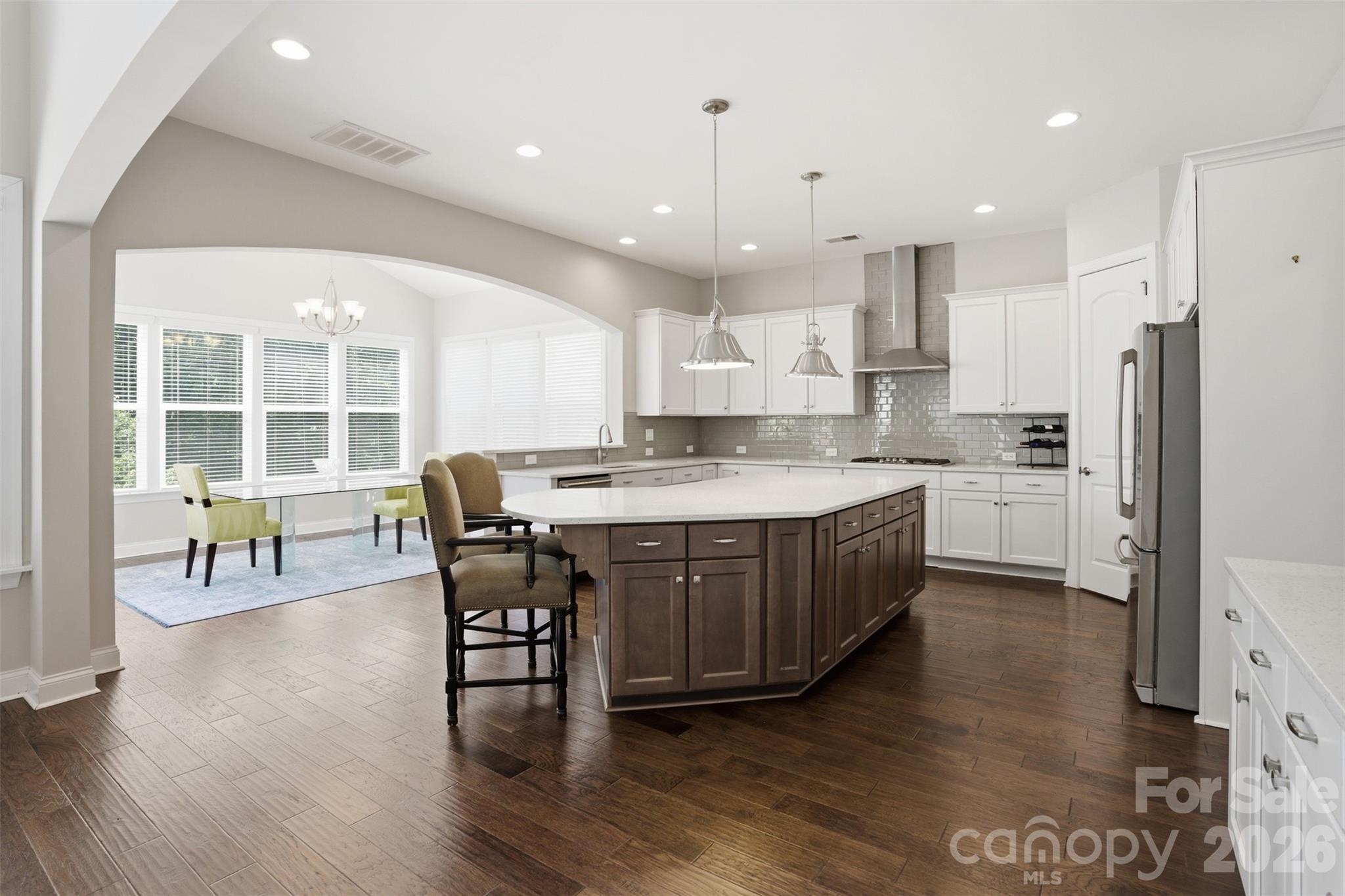 14022 Salem Ridge Road Huntersville, NC 28078 - Photo 13 of 38 a kitchen with a table chairs sink refrigerator and cabinets