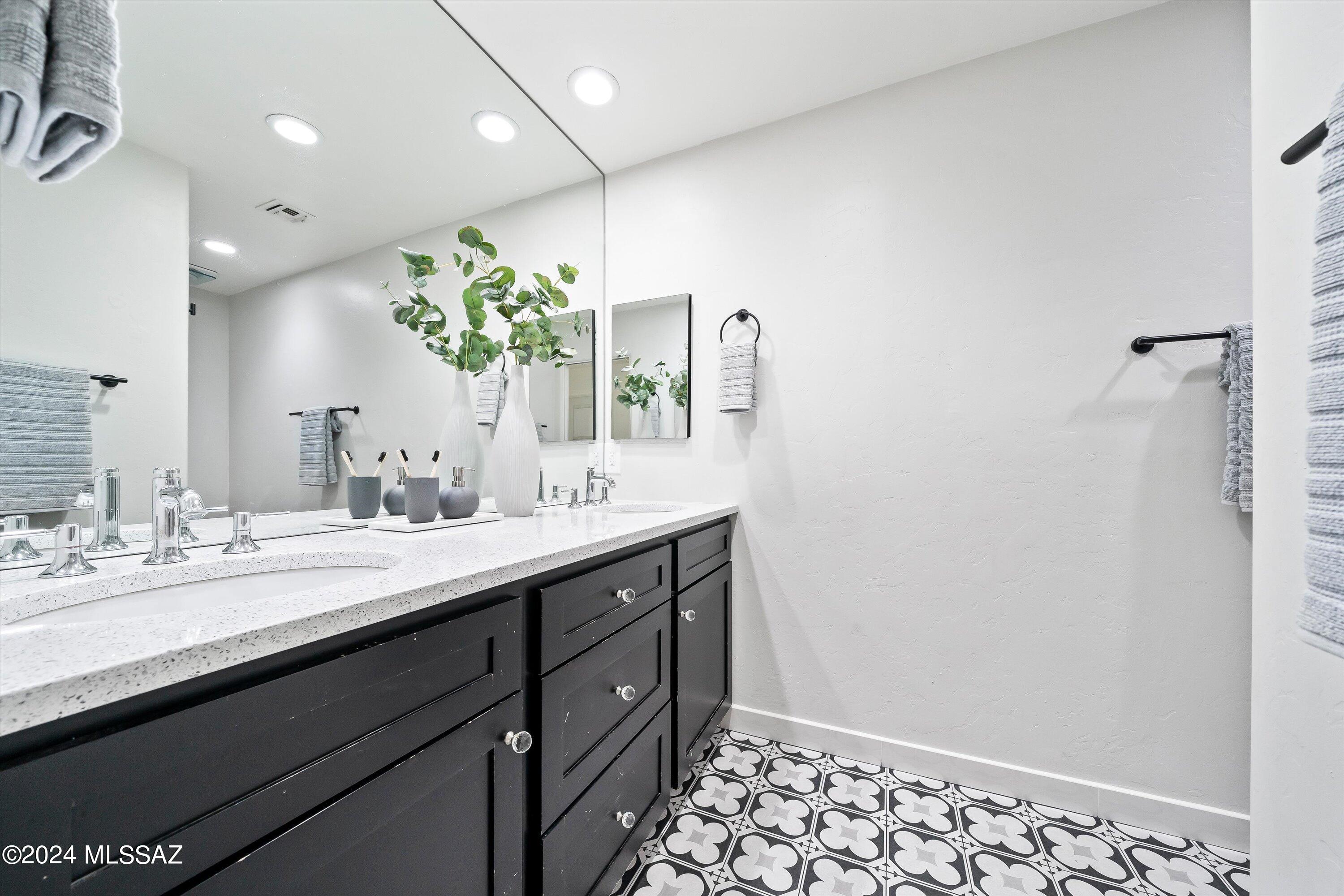 4951 North Valley View Road Tucson, AZ 85718 - Photo 34 of 45 Custom tile work, Quart counters and a walk-in shower.