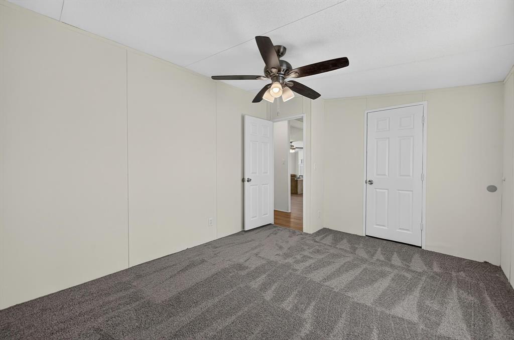 13405 Wheat Road Venus, TX 76084 - Photo 20 of 32 Spacious interior room featuring plush gray carpeting and light-toned wall paneling