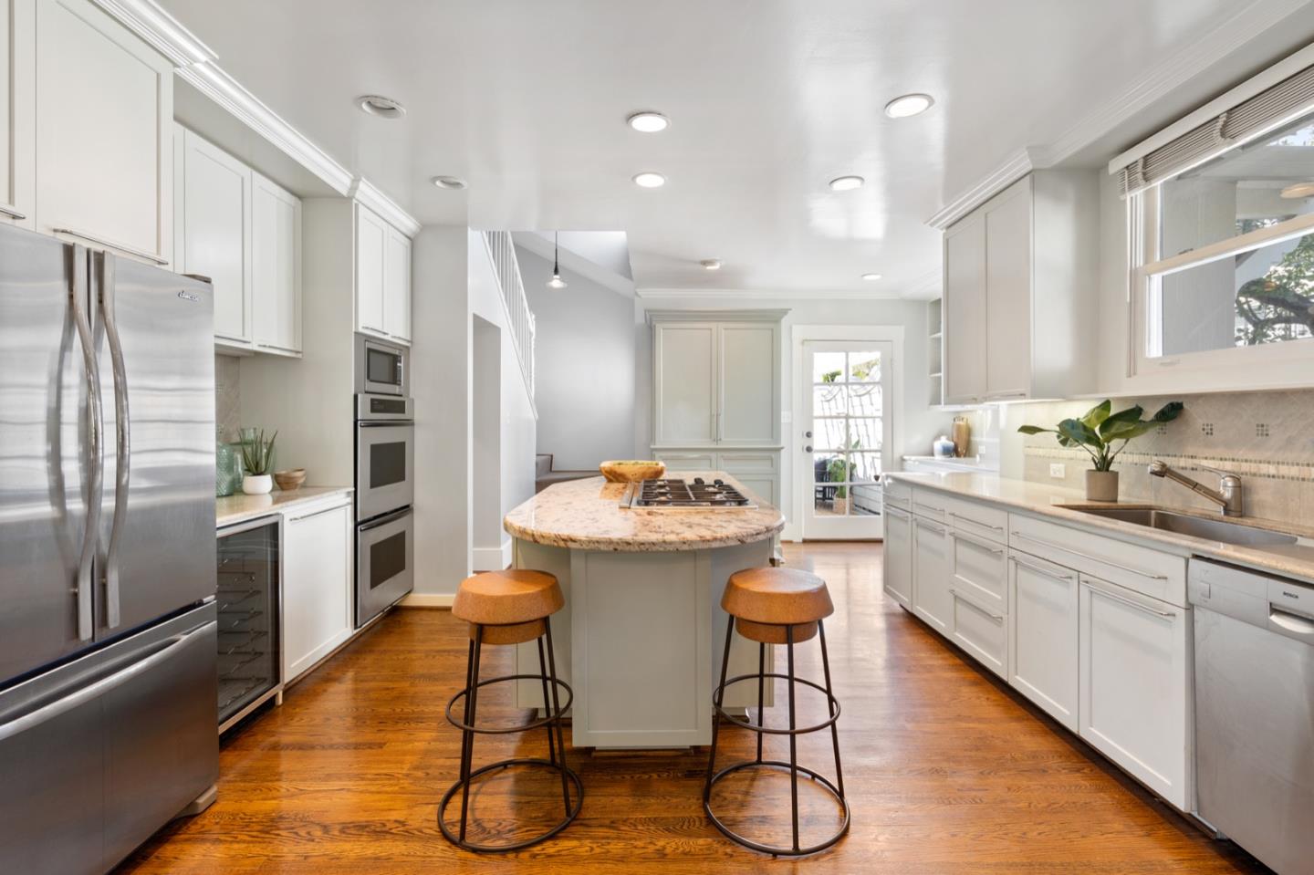 166 Warren Road San Mateo, CA 94401 - Photo 11 of 21 a kitchen with stainless steel appliances a stove a sink dishwasher a refrigerator and cabinets with wooden floor