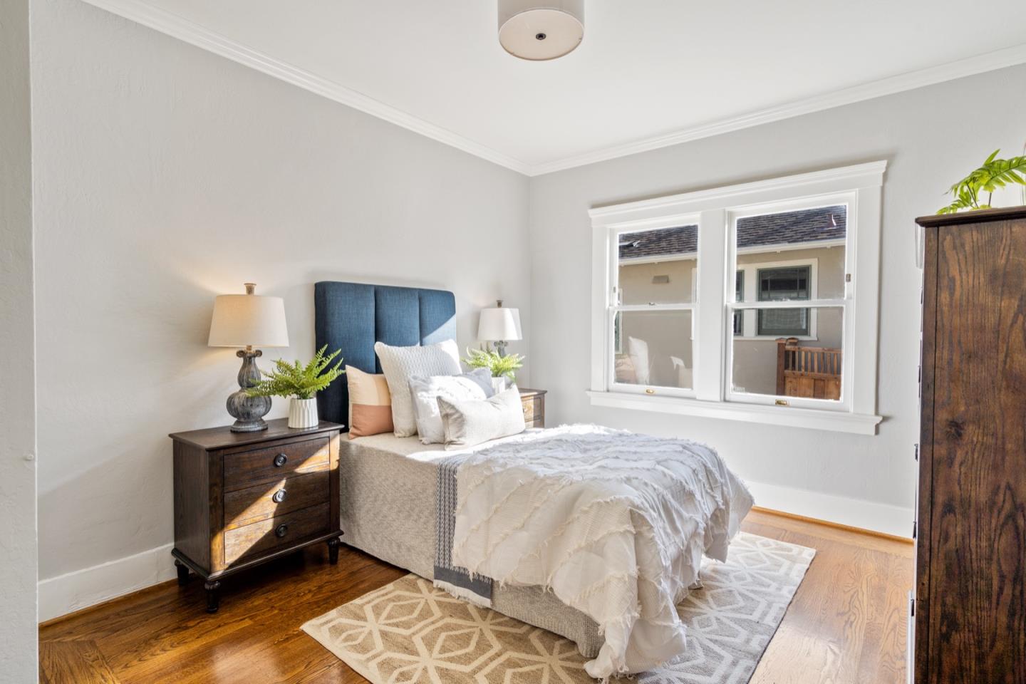 166 Warren Road San Mateo, CA 94401 - Photo 15 of 21 a bedroom with a bed table and window