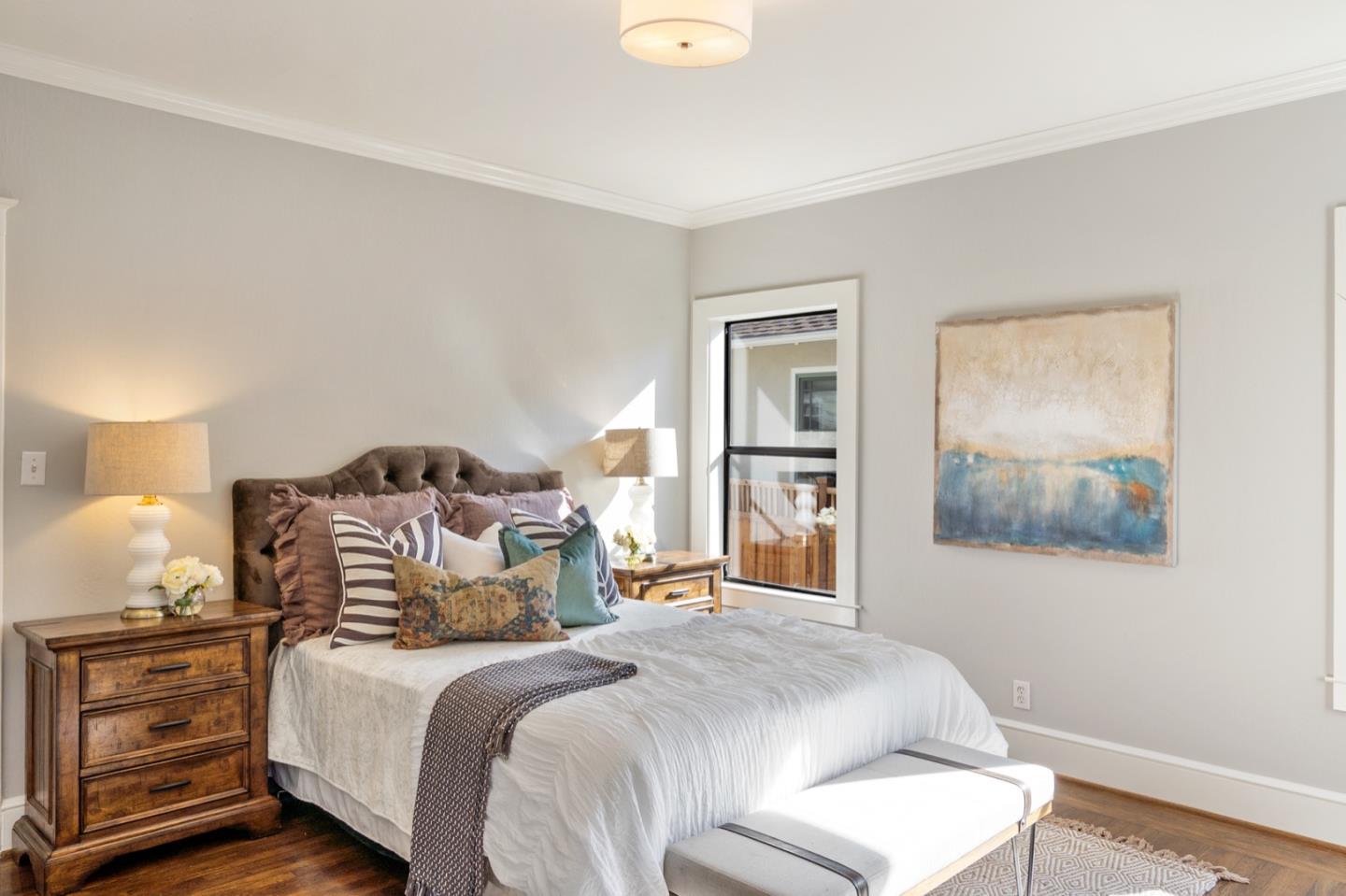 166 Warren Road San Mateo, CA 94401 - Photo 16 of 21 a bedroom with a bed and a painting on the wall