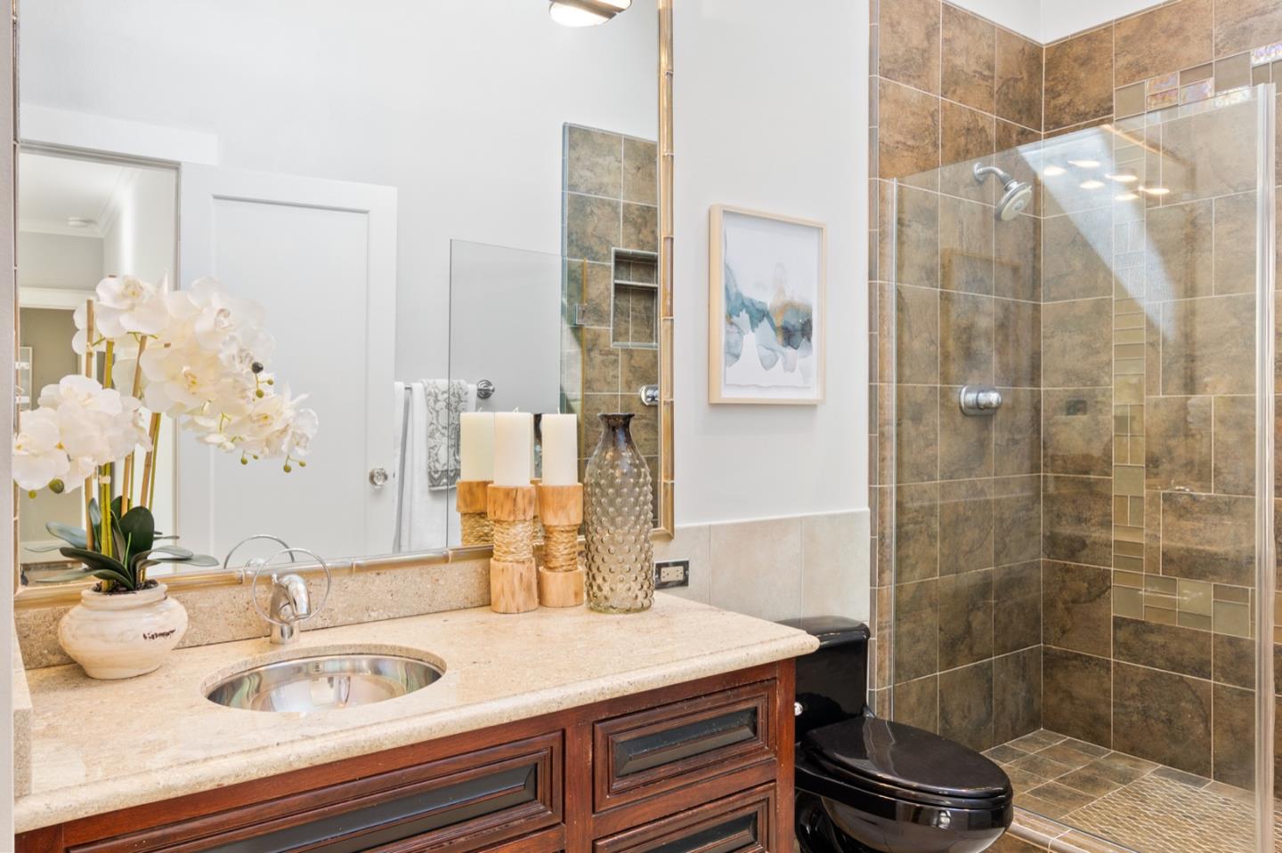 166 Warren Road San Mateo, CA 94401 - Photo 17 of 21 a bathroom with a sink and a mirror