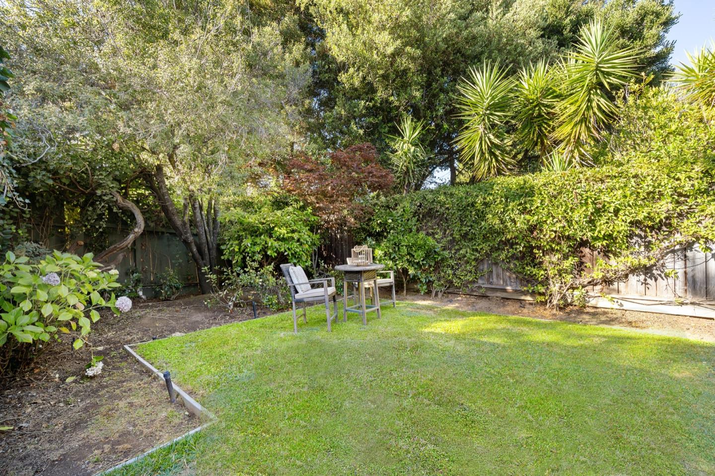 166 Warren Road San Mateo, CA 94401 - Photo 21 of 21 a view of a backyard with table and chairs and potted plants