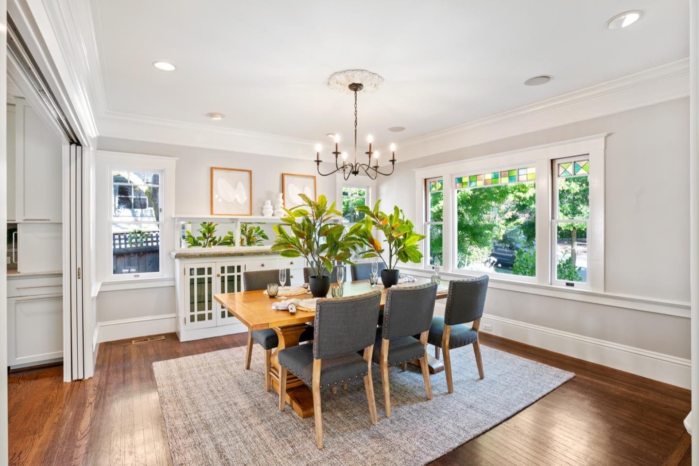 166 Warren Road San Mateo, CA 94401 - Photo 7 of 21 a dining room with furniture a chandelier and wooden floor
