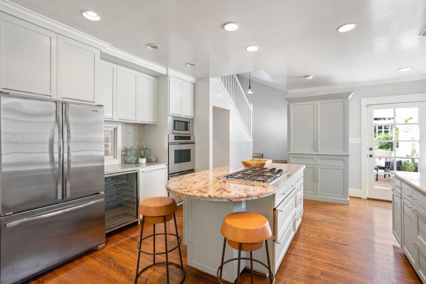 166 Warren Road San Mateo, CA 94401 - Photo 9 of 21 a kitchen with stainless steel appliances kitchen island granite countertop a refrigerator and a stove top oven