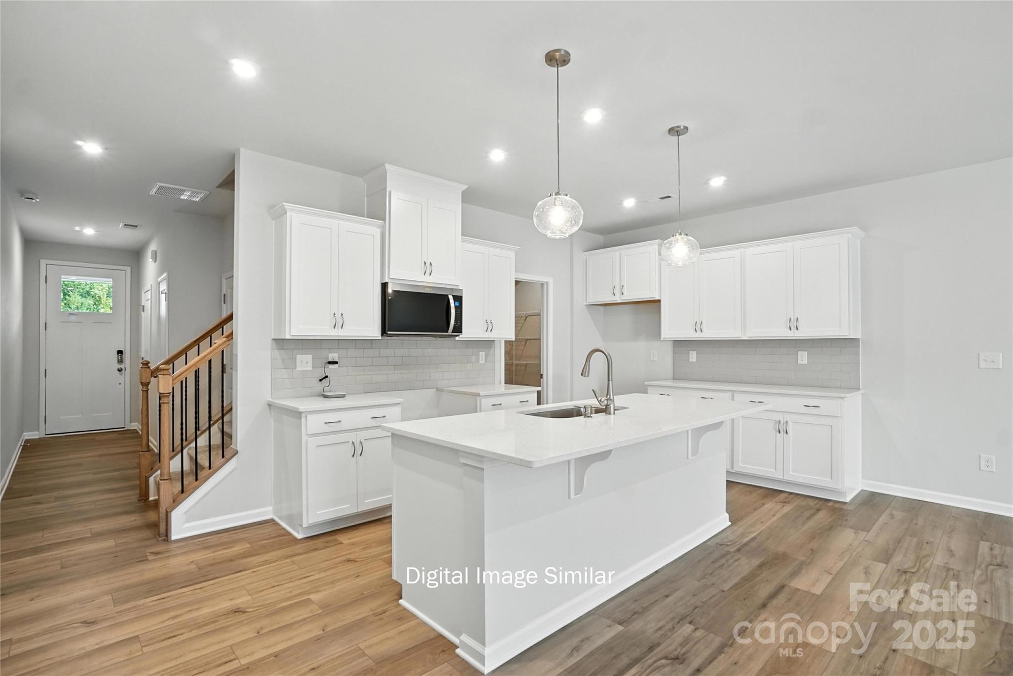 1209 Vibrant Road Charlotte, NC 28215 - Photo 2 of 8 a kitchen with white cabinets appliances and sink