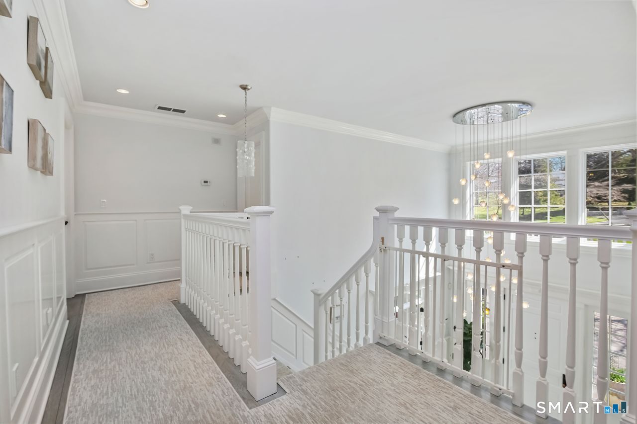 127 Fields Rock Road Fairfield, CT 06890 - Photo 18 of 40 a view of hallway with chandelier