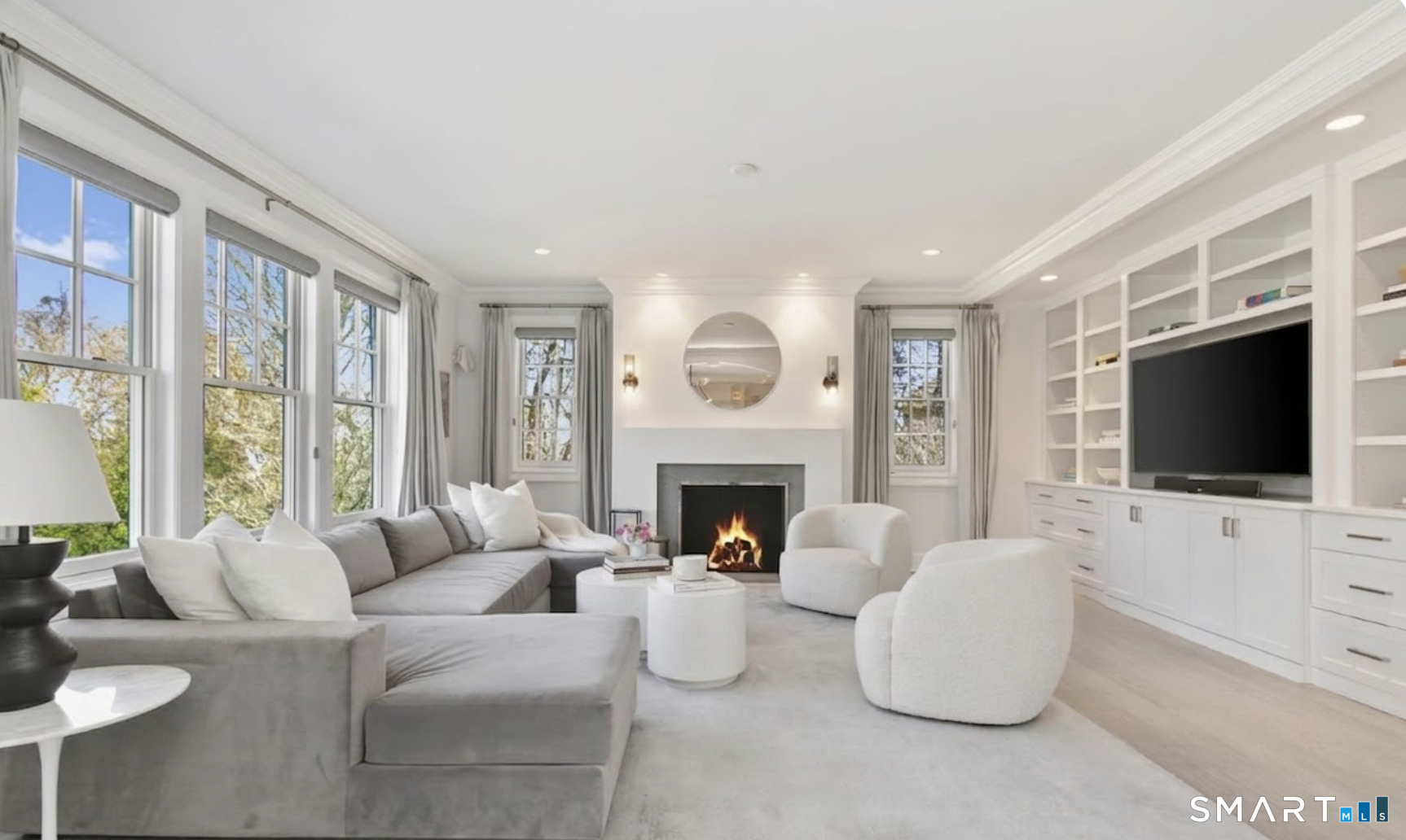 127 Fields Rock Road Fairfield, CT 06890 - Photo 18 of 45 a living room with furniture a flat screen tv and a fireplace