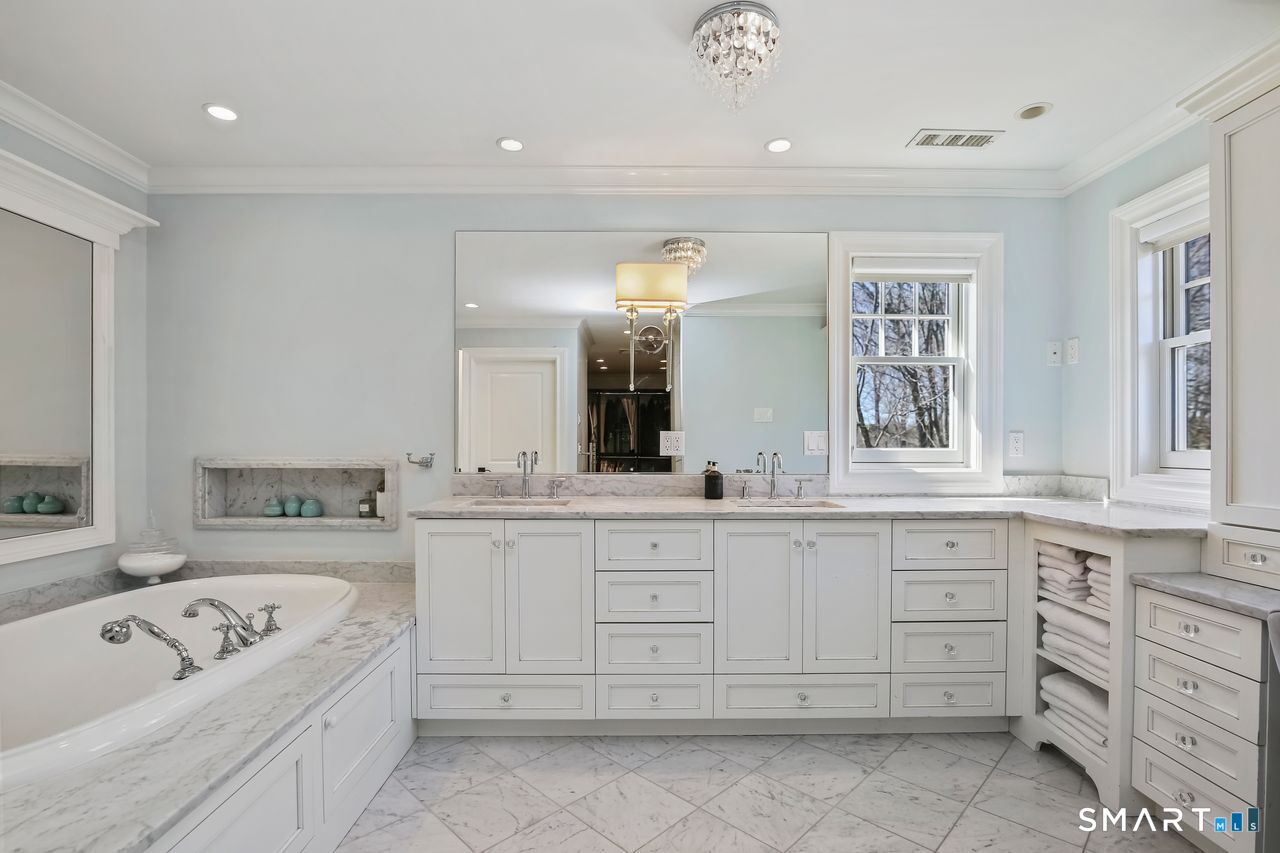127 Fields Rock Road Fairfield, CT 06890 - Photo 25 of 40 a spacious en suite bathroom with a granite countertop tub sink and mirror