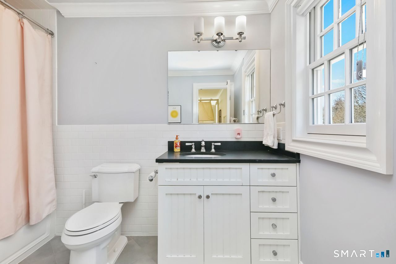 127 Fields Rock Road Fairfield, CT 06890 - Photo 30 of 40 a bathroom with a sink and a toilet