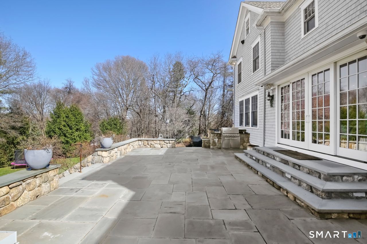 127 Fields Rock Road Fairfield, CT 06890 - Photo 33 of 40 a view of a backyard with sitting area and garden