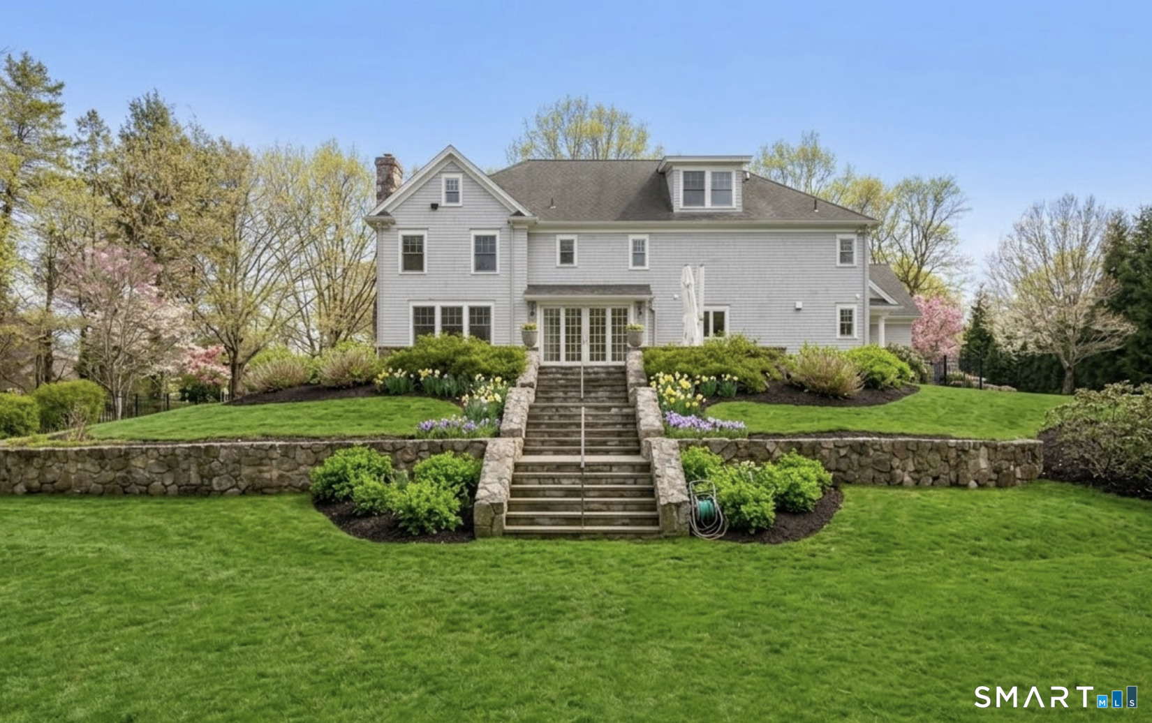 127 Fields Rock Road Fairfield, CT 06890 - Photo 34 of 40 a front view of a house with a garden