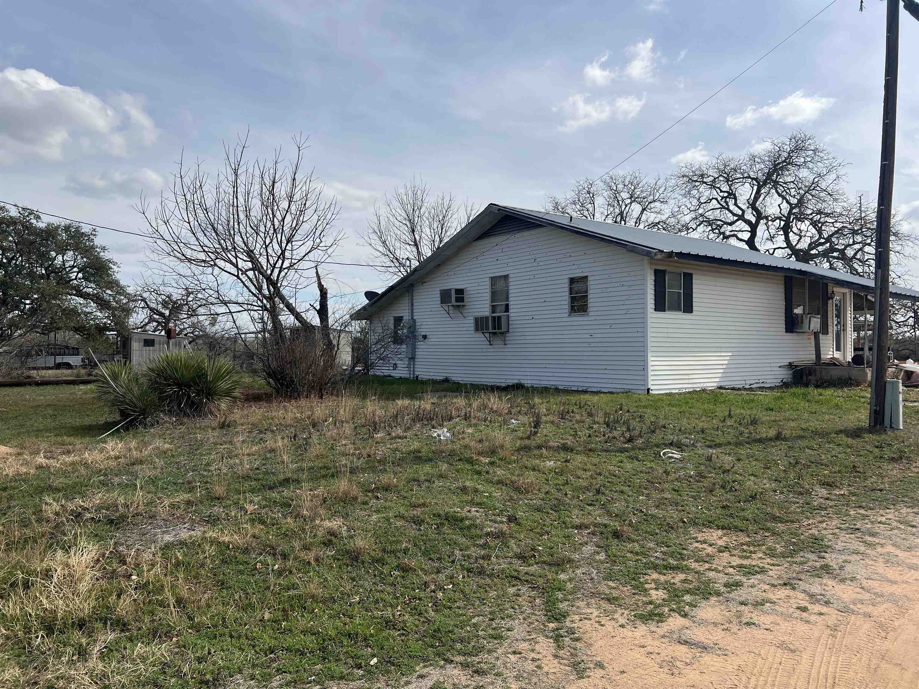 1034 Ranch Road 2545 Kingsland, TX 78639 - Photo 6 of 30 a front view of a house with garden