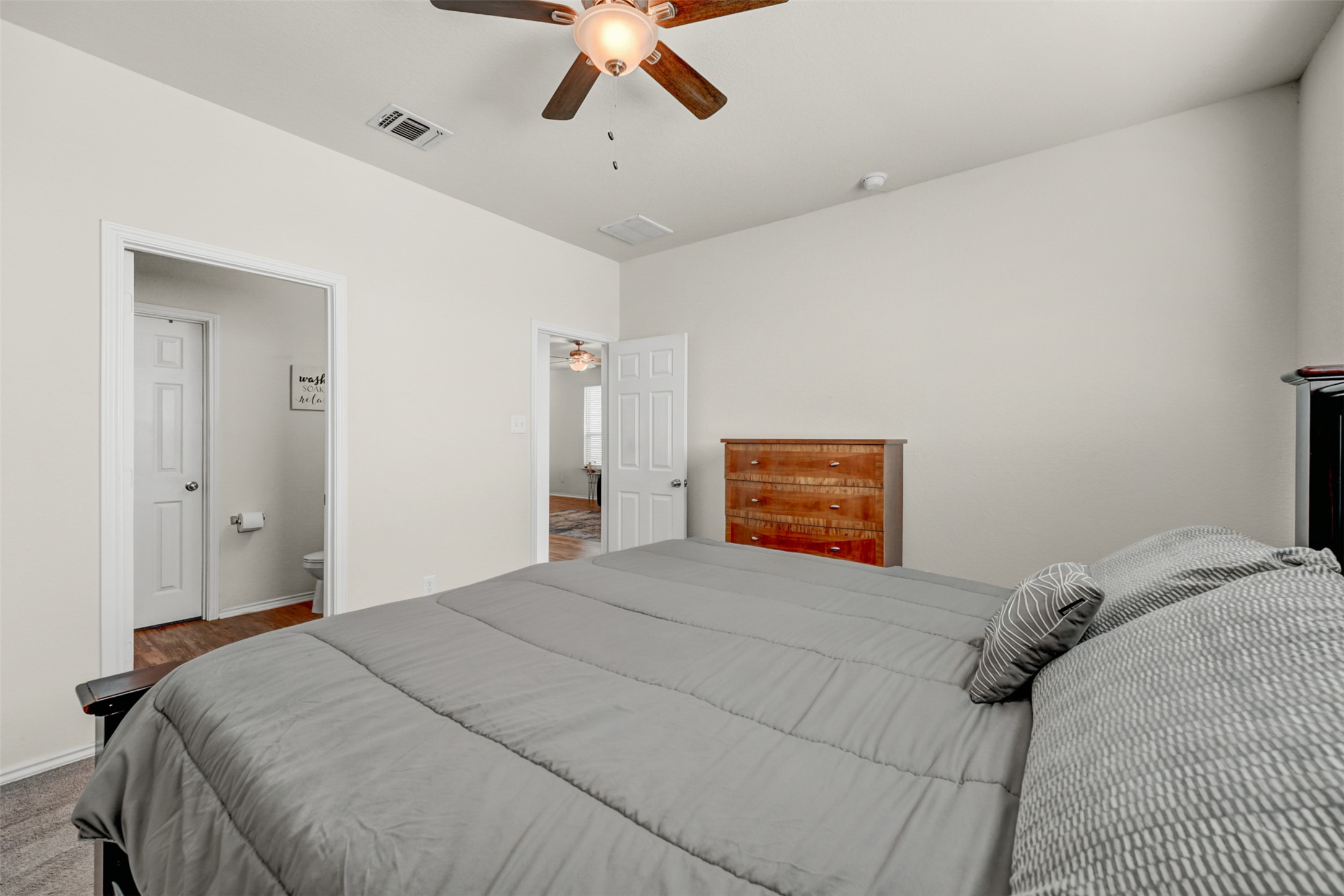 213 Ibis Falls Loop Jarrell, TX 76537 - Photo 17 of 37 Relax in this well-lit bedroom featuring a ceiling fan for optimal comfort and airflow.