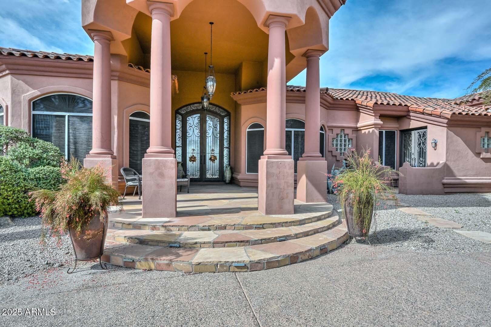 8540 East McDowell Road, Unit 55 Mesa, AZ 85207 - Photo 14 of 111 a front view of a house with a garden