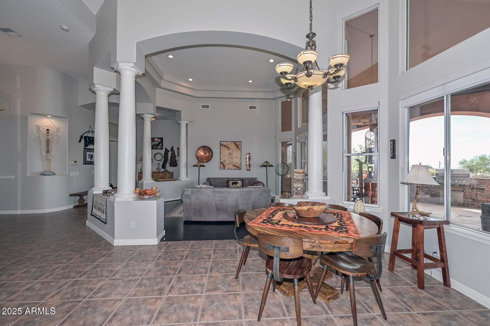 8540 East McDowell Road, Unit 55 Mesa, AZ 85207 - Photo 25 of 111 a view of a dining room with furniture and a chandelier