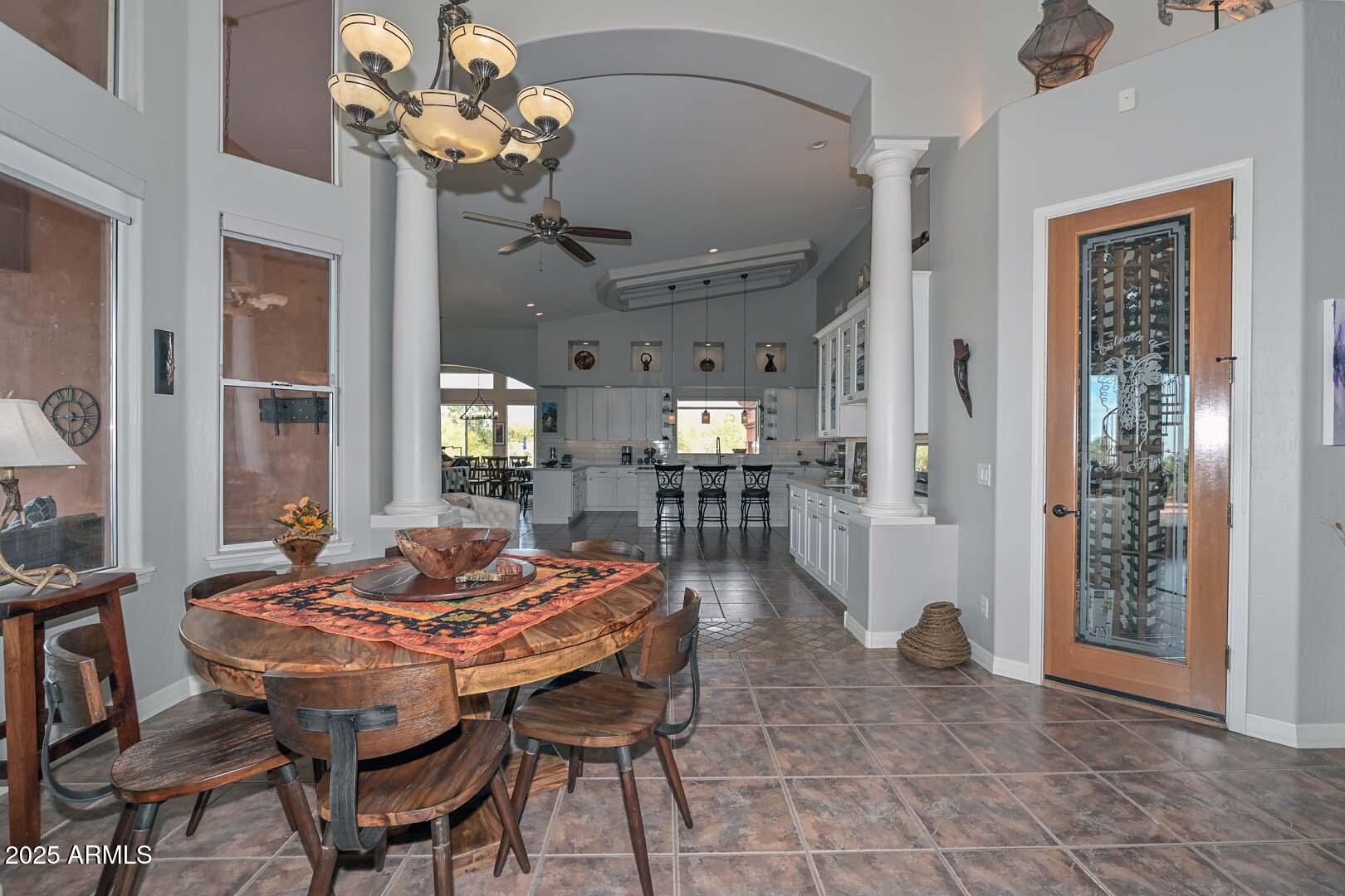 8540 East McDowell Road, Unit 55 Mesa, AZ 85207 - Photo 28 of 111 a view of a dining room with furniture and a chandelier