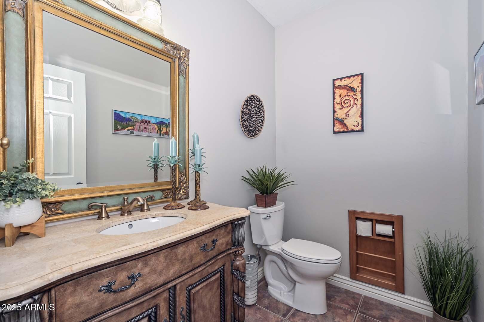 8540 East McDowell Road, Unit 55 Mesa, AZ 85207 - Photo 34 of 111 a bathroom with a granite countertop sink a toilet and a mirror