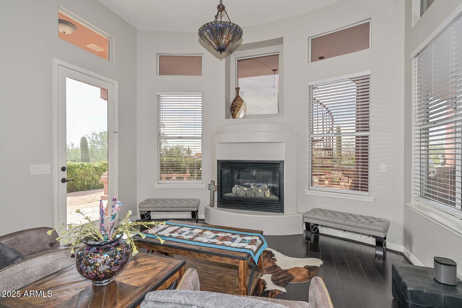 8540 East McDowell Road, Unit 55 Mesa, AZ 85207 - Photo 58 of 111 a living room with furniture a window and a fireplace