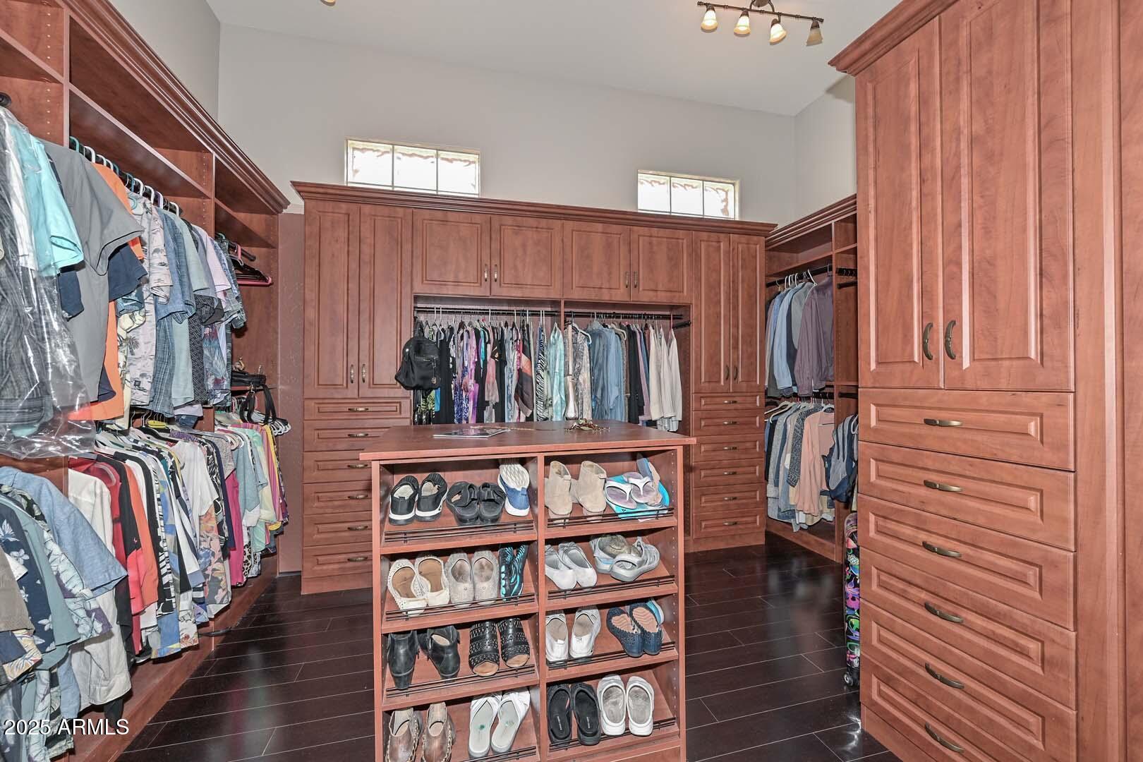 8540 East McDowell Road, Unit 55 Mesa, AZ 85207 - Photo 65 of 111 a view of walk in closet with clothes and shoes