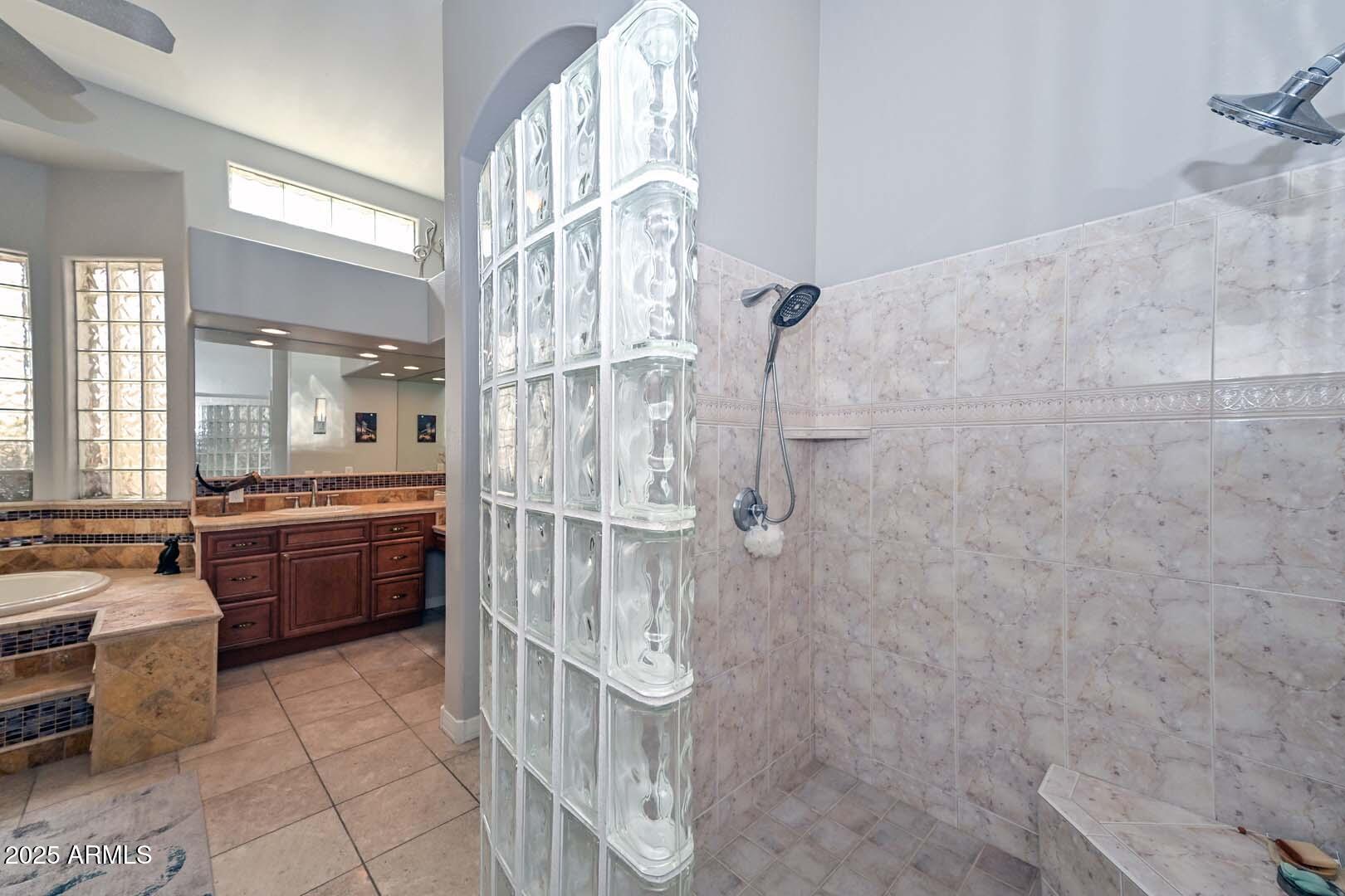 8540 East McDowell Road, Unit 55 Mesa, AZ 85207 - Photo 66 of 111 a large bathroom with a double vanity sink a toilet a mirror and shower