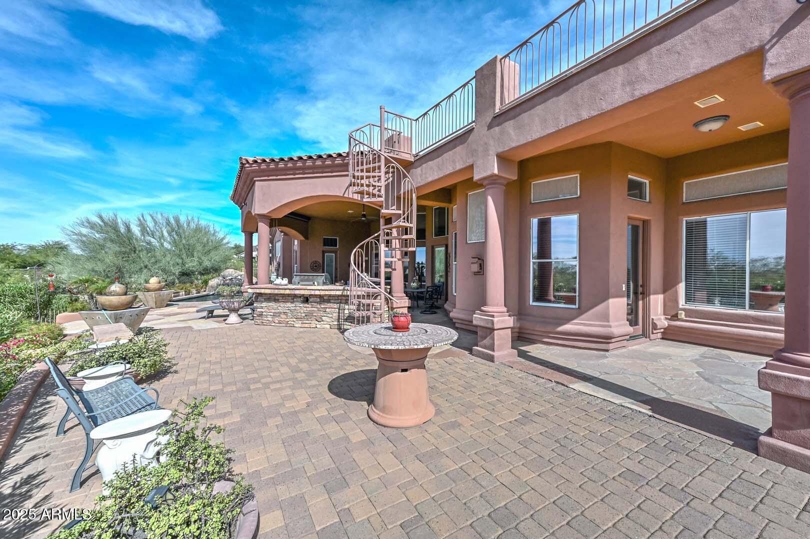 8540 East McDowell Road, Unit 55 Mesa, AZ 85207 - Photo 77 of 111 a view of a building with potted plants and a bench