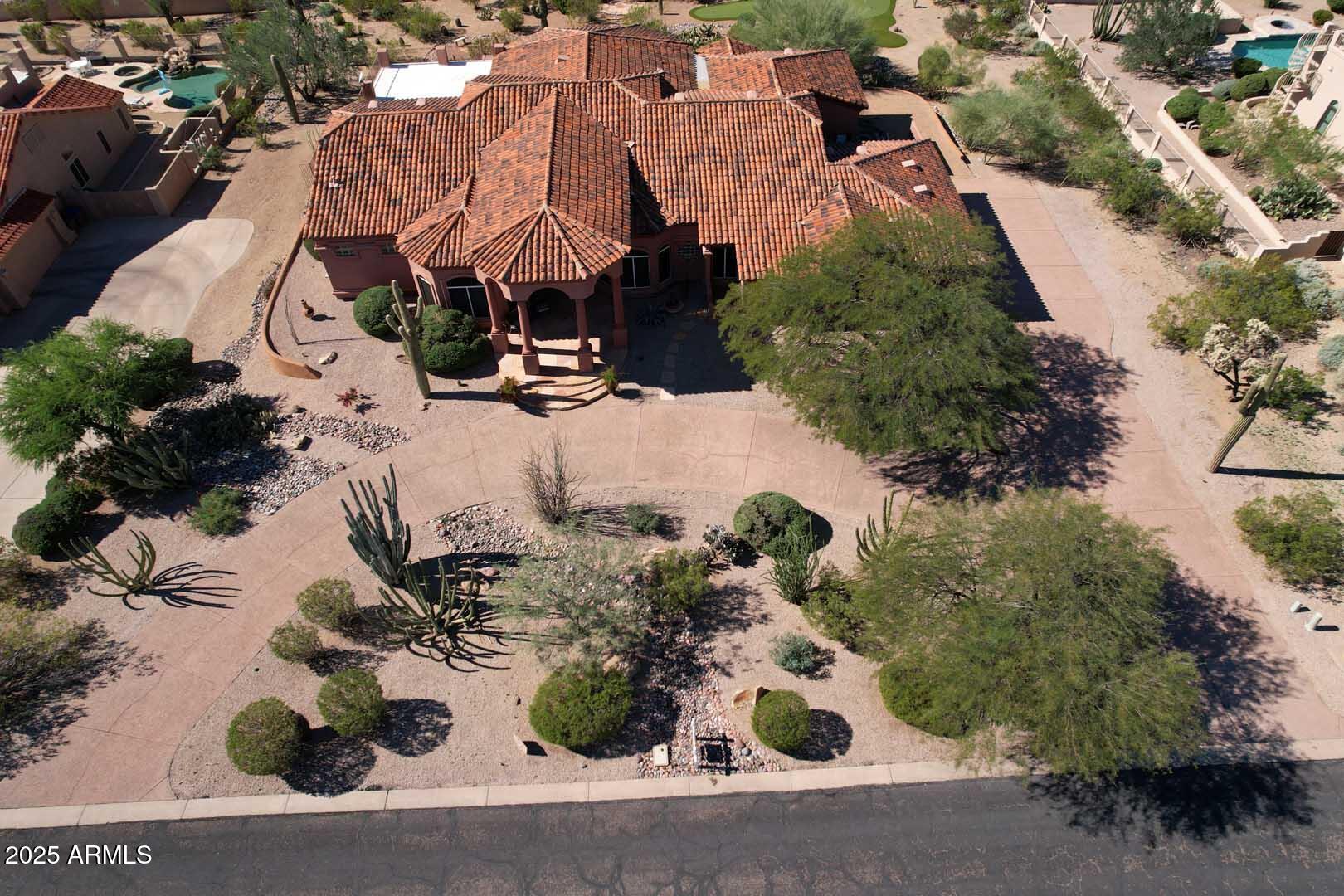 8540 East McDowell Road, Unit 55 Mesa, AZ 85207 - Photo 97 of 111 an aerial view of a house with a yard and garden