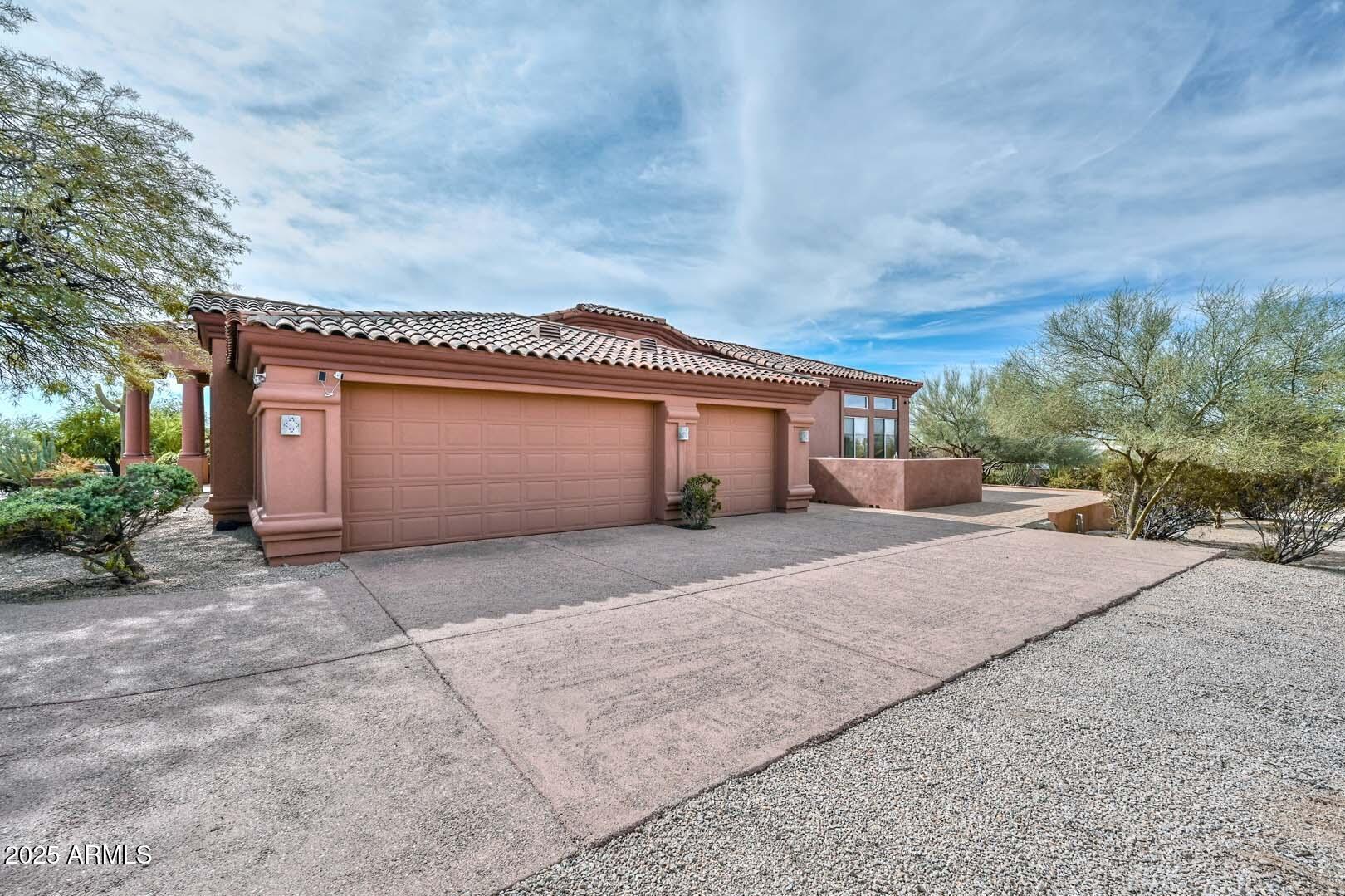 8540 East McDowell Road, Unit 55 Mesa, AZ 85207 - Photo 10 of 111 a front view of a house with a yard and garage