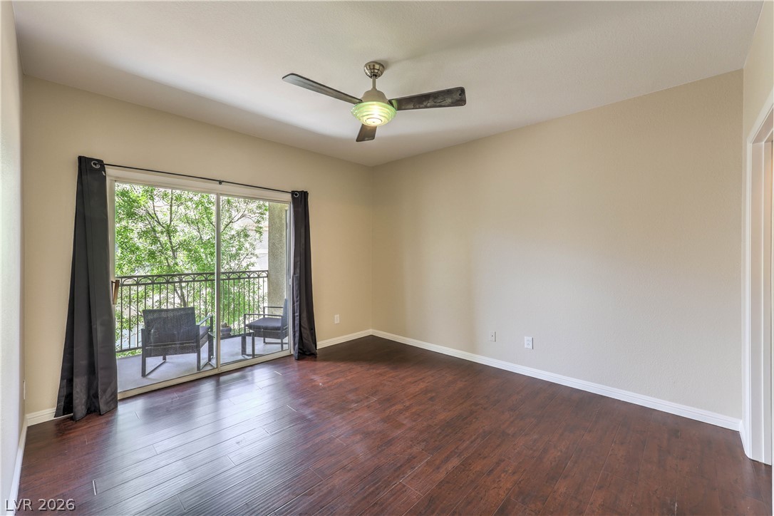 9050 West Warm Springs Road, Unit 2033 Las Vegas, NV 89148 - Photo 16 of 30 Rich hardwood floors complement a private balcony, offering a tranquil outdoor retreat.