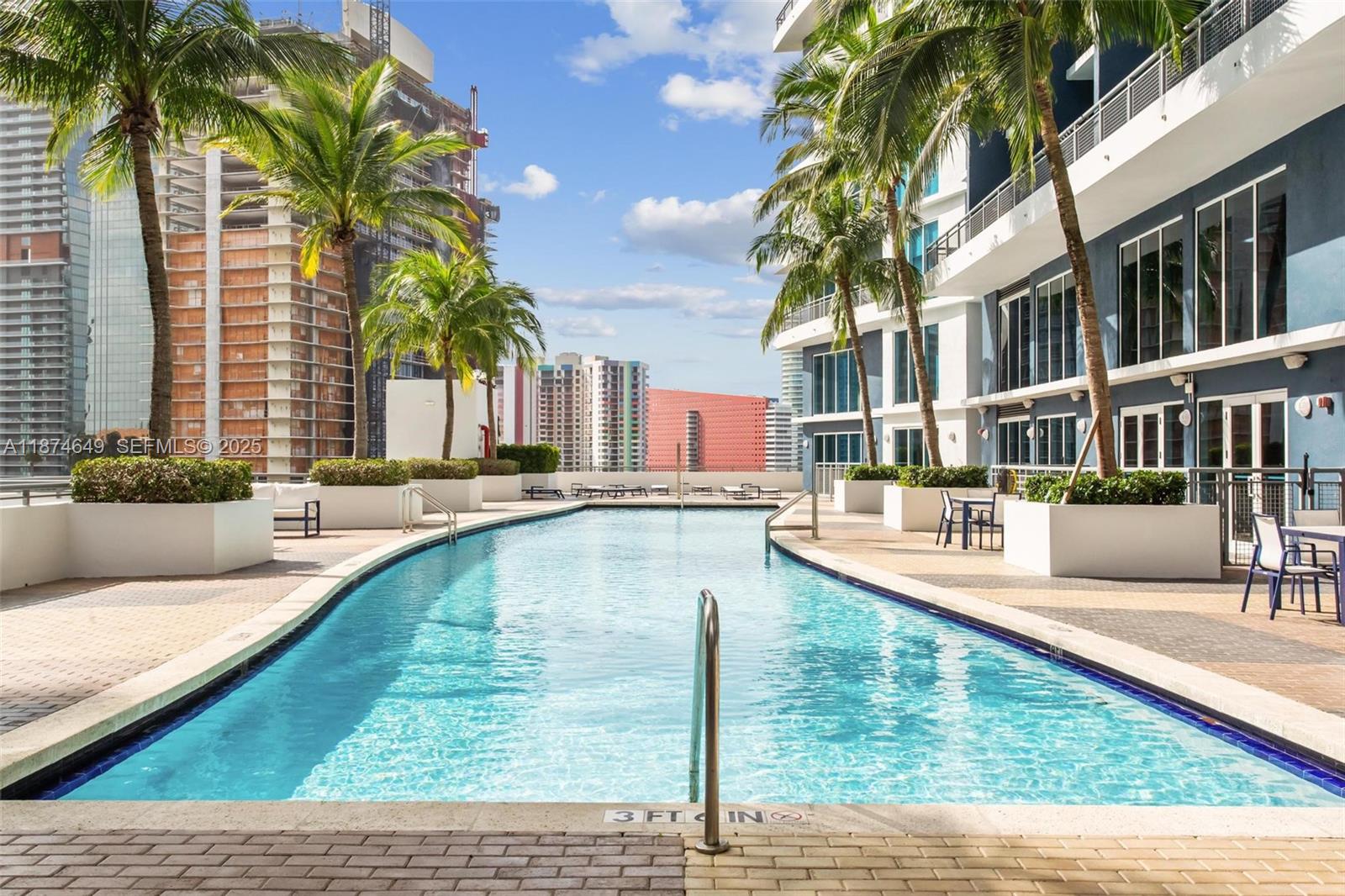 60 Southwest 13th Street, Unit 4413 Miami, FL 33130 - Photo 30 of 41 a swimming pool with outdoor seating and yard